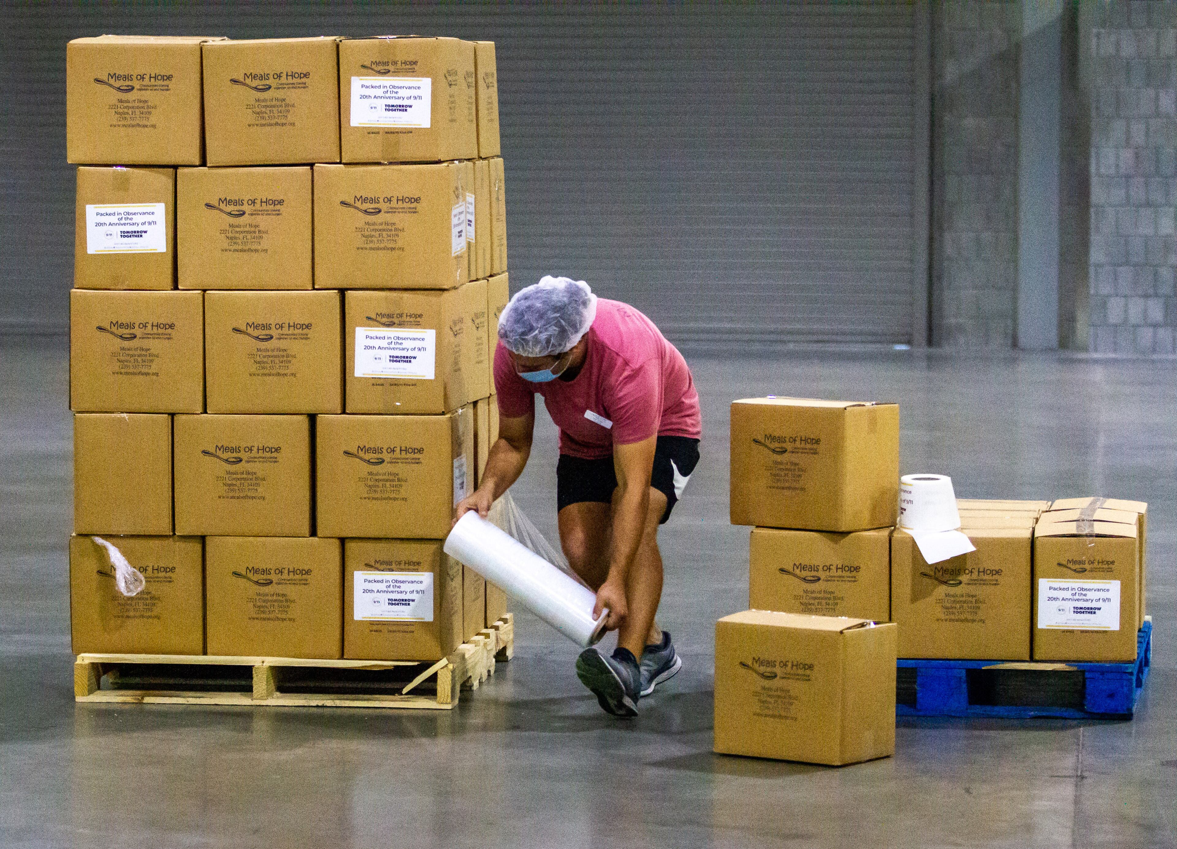 Matt Durfee with Meals of Hope raps up a pallet of prepared meals during the 9/11 National Day of Service at the Georgia World Congress Center on Saturday, September 11, 2021. Each pallet will hold 15,840 meals each. STEVE SCHAEFER FOR THE ATLANTA JOURNAL-CONSTITUTION