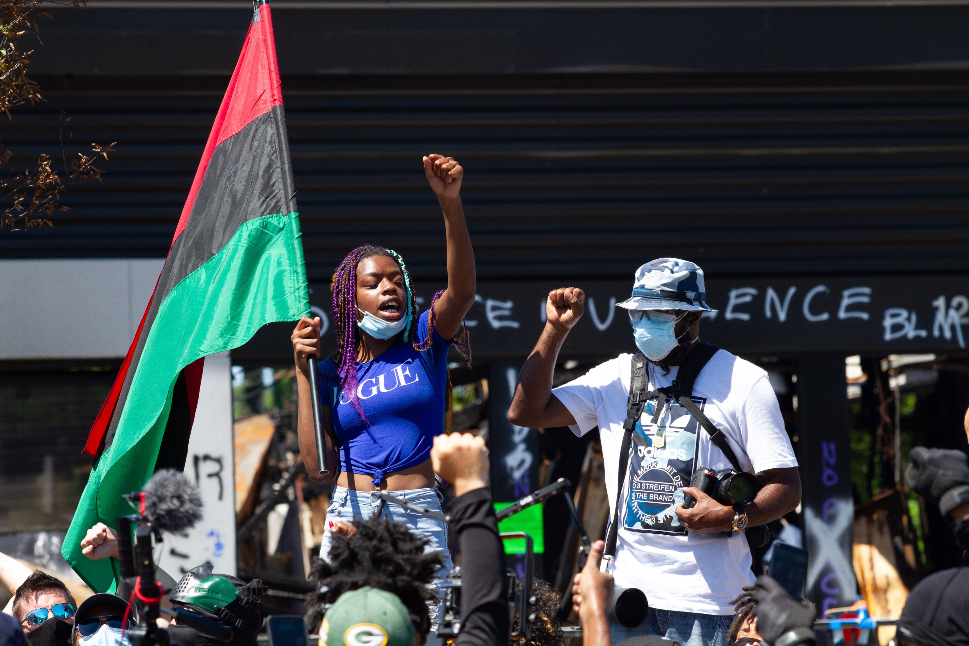 Yvette Dixon waves her flag during a rally at the Wendy's on University Avenue in Atlanta on Saturday, July 11, 2020. STEVE SCHAEFER FOR THE ATLANTA JOURNAL-CONSTITUTION