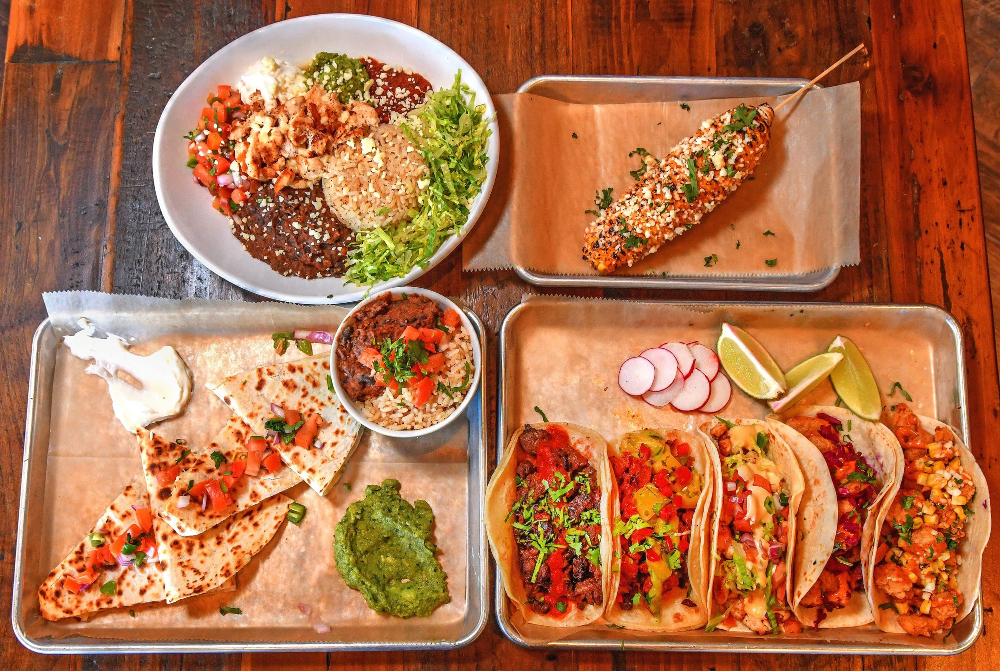 From top left: Cantina Bowl, Grilled Street Corn, Quesadillas (bottom left) Carne Asada, Al Pastor, Grilled Chicken, Fried Catfish and Fried Shrimp Tacos at Lazy Llama Cantina. CONTRIBUTED BY CHRIS HUNT PHOTOGRAPHY