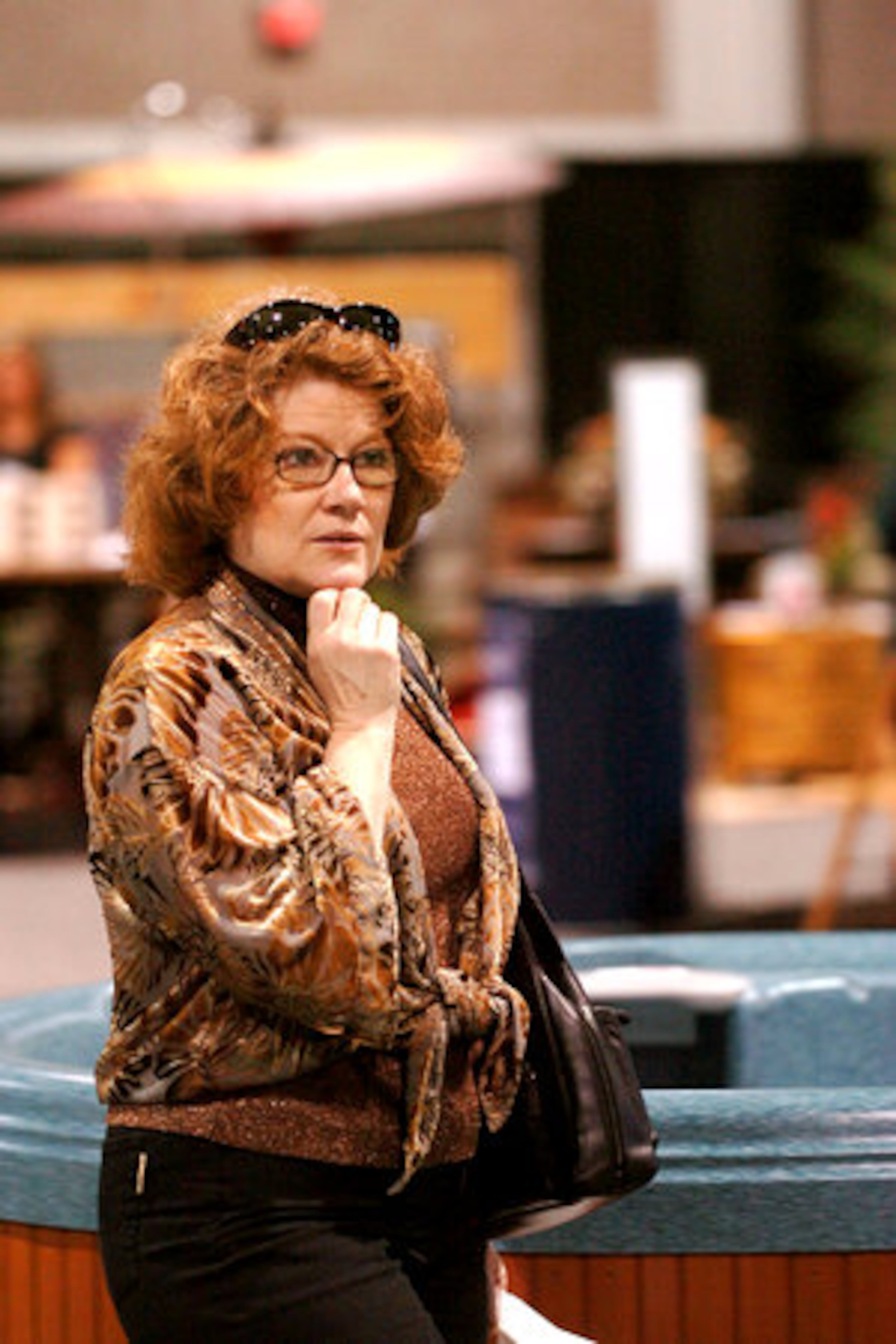 Candice Serafin, of Peachtree City, looks at the hot tub display.