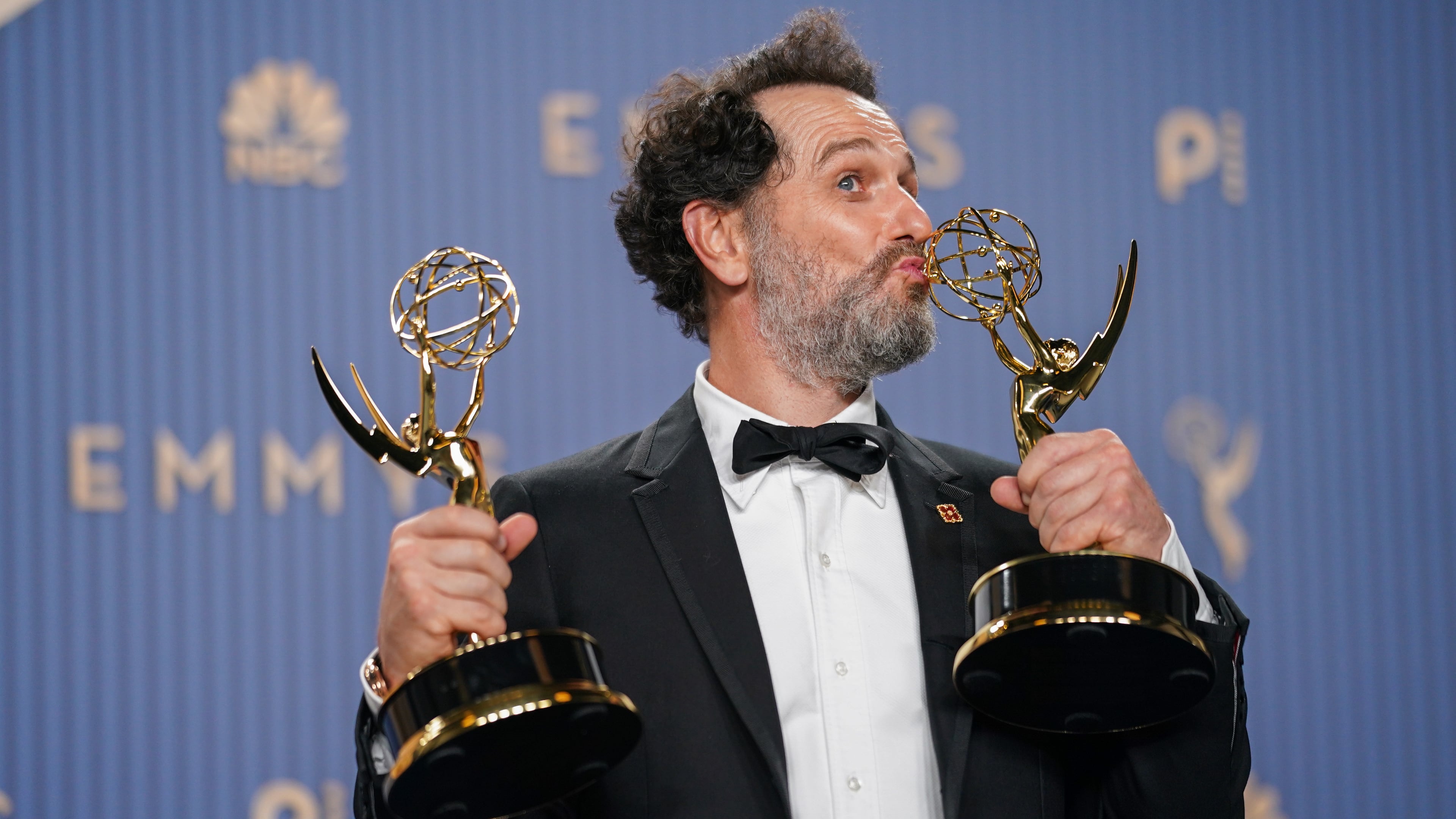 Matthew Rhys poses in the press room with the awards for outstanding lead actor in a limited or anthology series or movie for "The Beast In Me," and outstanding lead actor in a comedy series for "Widow's Bay" during the 78th Emmy Awards on Monday, Sept. 14, 2026, at the JW Marriott in Los Angeles. (Photo by Richard Shotwell/Invision/AP)