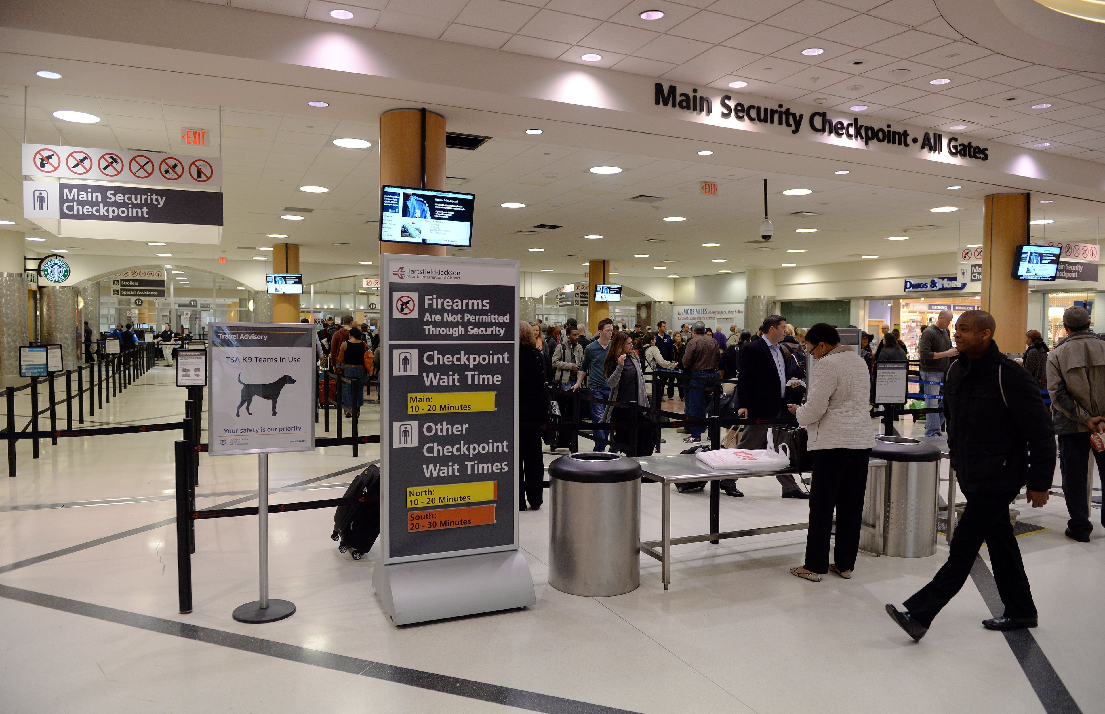 NOVEMBER 16, 2015 ATLANTA Passengers proceed through the main security checkpoint Monday. A visibly increased police presence is apparent, as Mayor Kasim Reed, airport manager Miguel Southwell, Atlanta Police Chief George Turner, the FBI and other officials hold a press conference regarding security at Hartsfield Jackson International Airport Monday, November 16, 2015. KENT D. JOHNSON/KDJOHNSON@AJC.COM