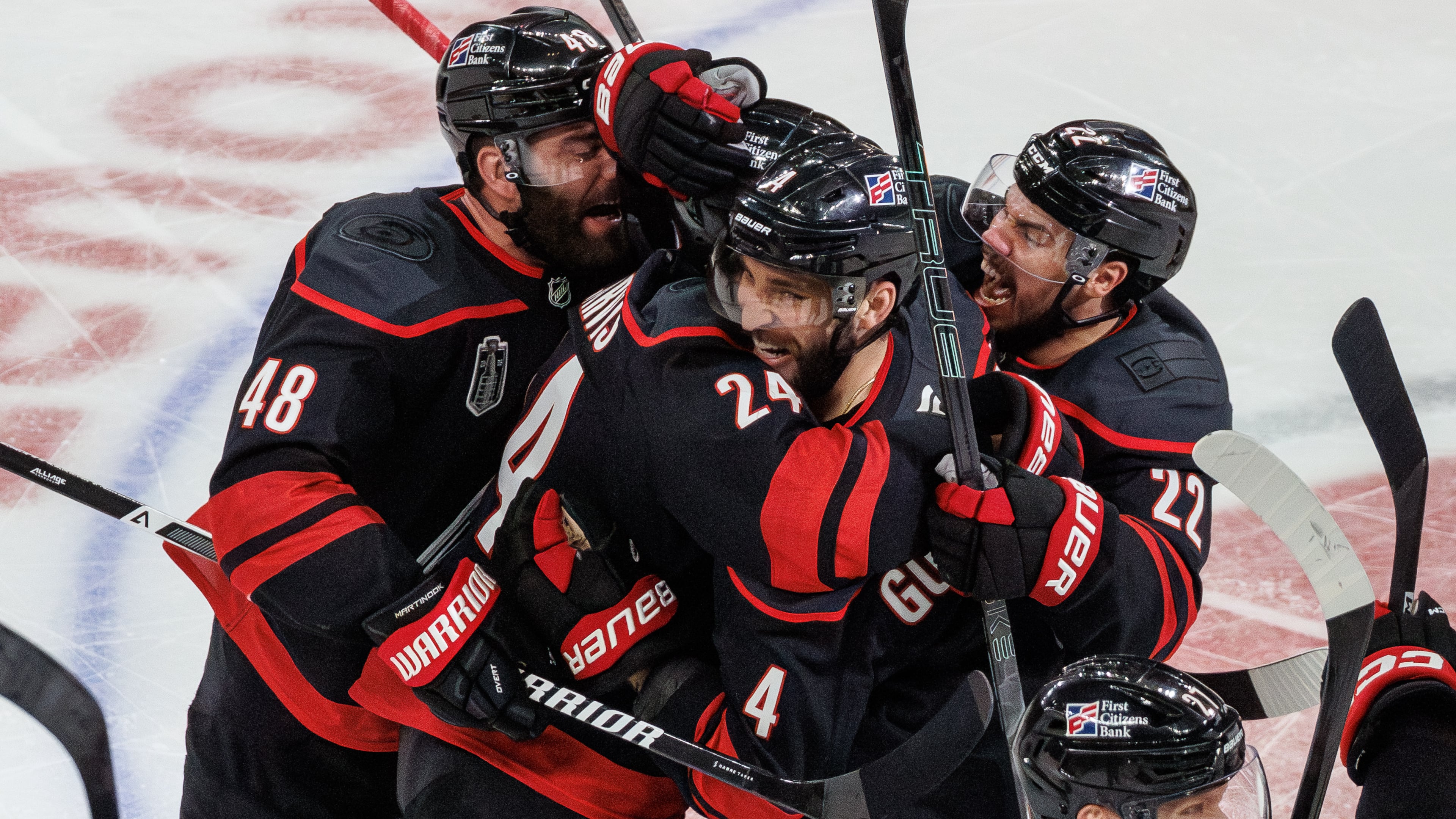 Carolina Hurricanes' Jordan Martinook (48), Seth Jarvis (24), Shayne Gostisbehere (4), and Logan Stankoven (22) ceelbrate after Jarvis scored the game-winning goal against against the Vegas Golden Knights in overtime of Game 2 of the NHL hockey Stanley Cup Final series in Raleigh, N.C., Thursday, June 4, 2026. (AP Photo/Ben McKeown)