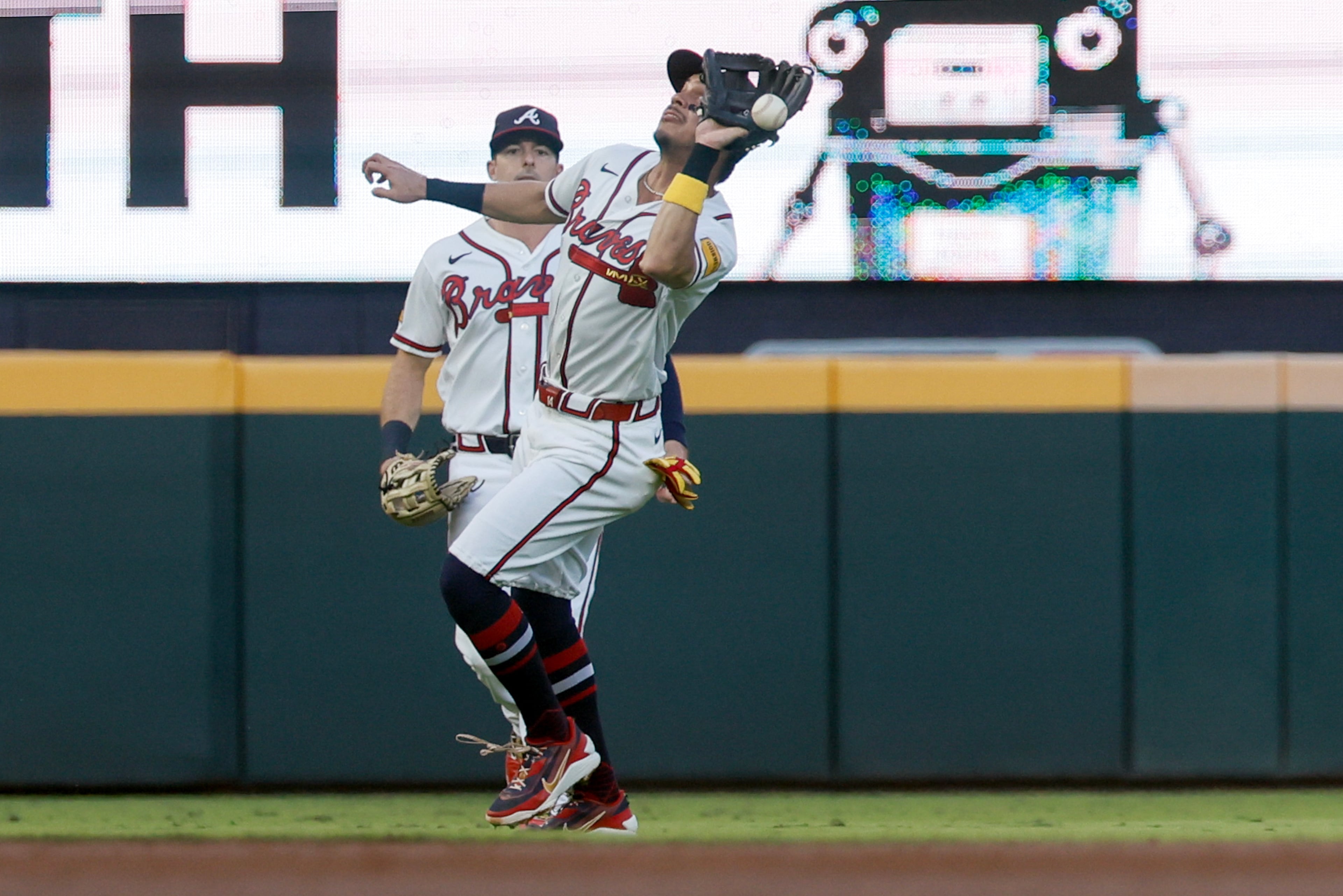 Atlanta Braves shortstop Mauricio Dubon (14) misses catching a shallow fly ball hit by Los Angeles Dodgers' Max Muncy, allowing a run to score, during the second inning of Game 4 of the MLB National League Division Series between the Atlanta Braves and the Los Angeles Dodgers, Wednesday, Oct. 7, 2026, in Atlanta. (Miguel Martinez/AJC)