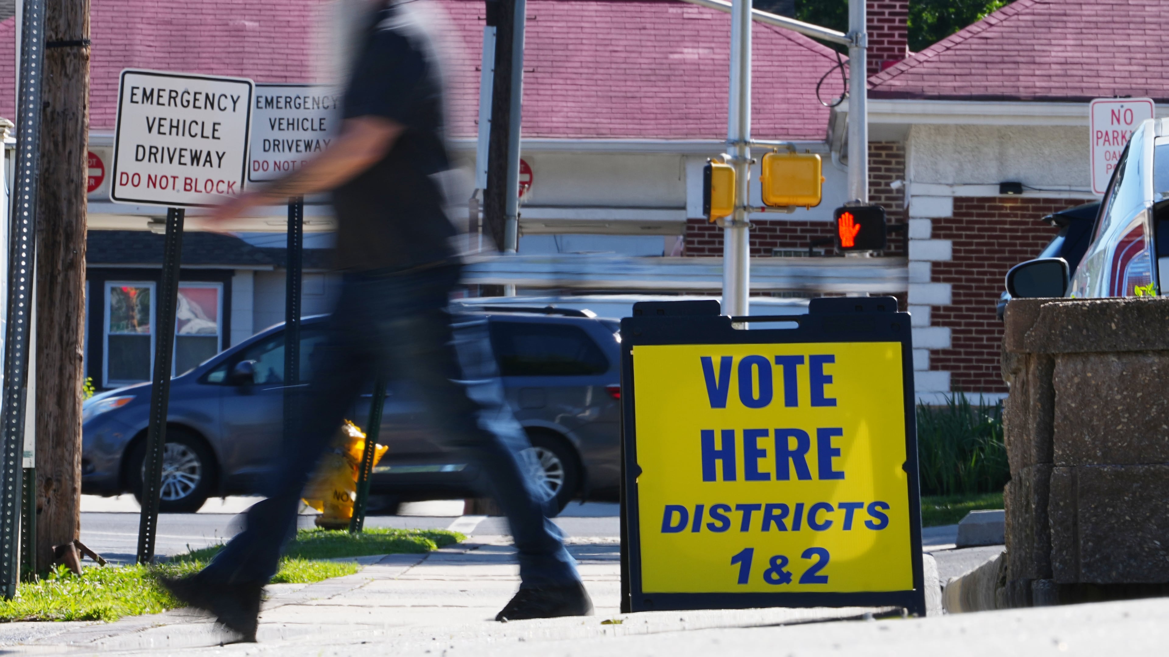 A person walks from a polling place for the New Jersey primary election in Oaklyn, N.J., Tuesday, June 2, 2026. (AP Photo/Matt Rourke)