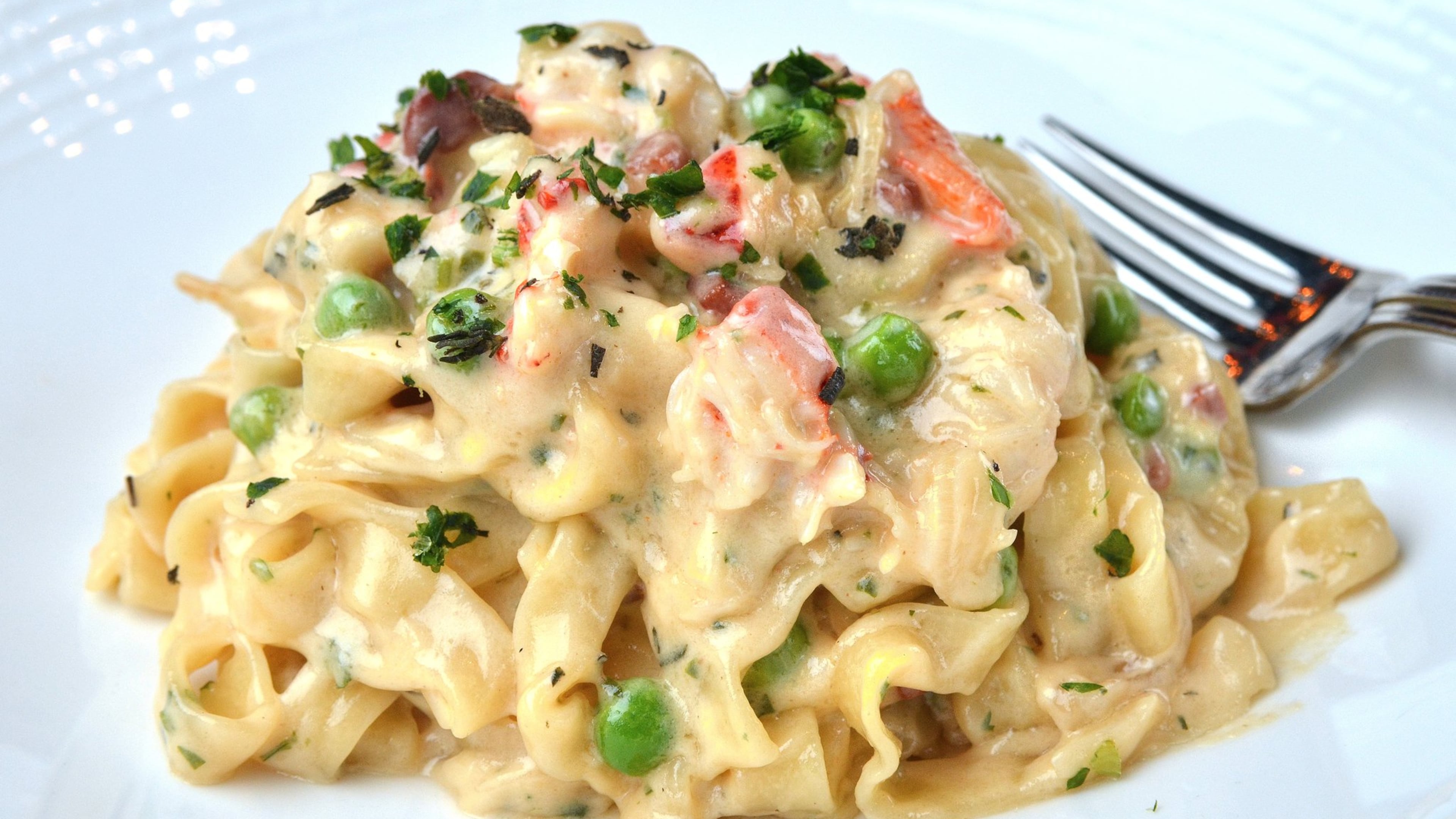 Osteria di Mare’s lobster carbonara is a luxurious play on the classic carbonara, with lobster, green peas and salty prosciutto stirred into house-made fettuccine. CHRIS HUNT / SPECIAL