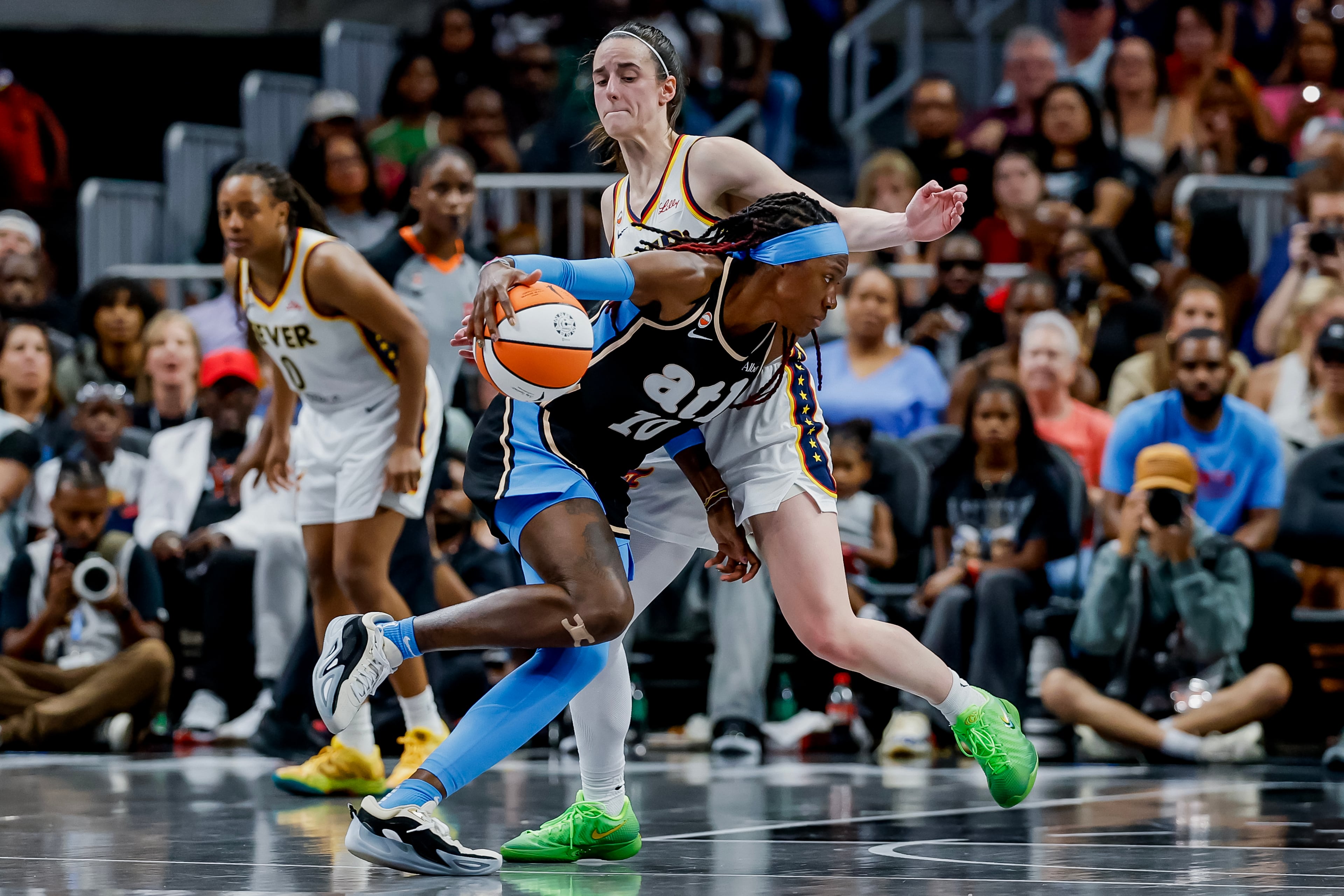 Clark defends against Dream guard Rhyne Howard (10). (Erik S. Lesser for the AJC)