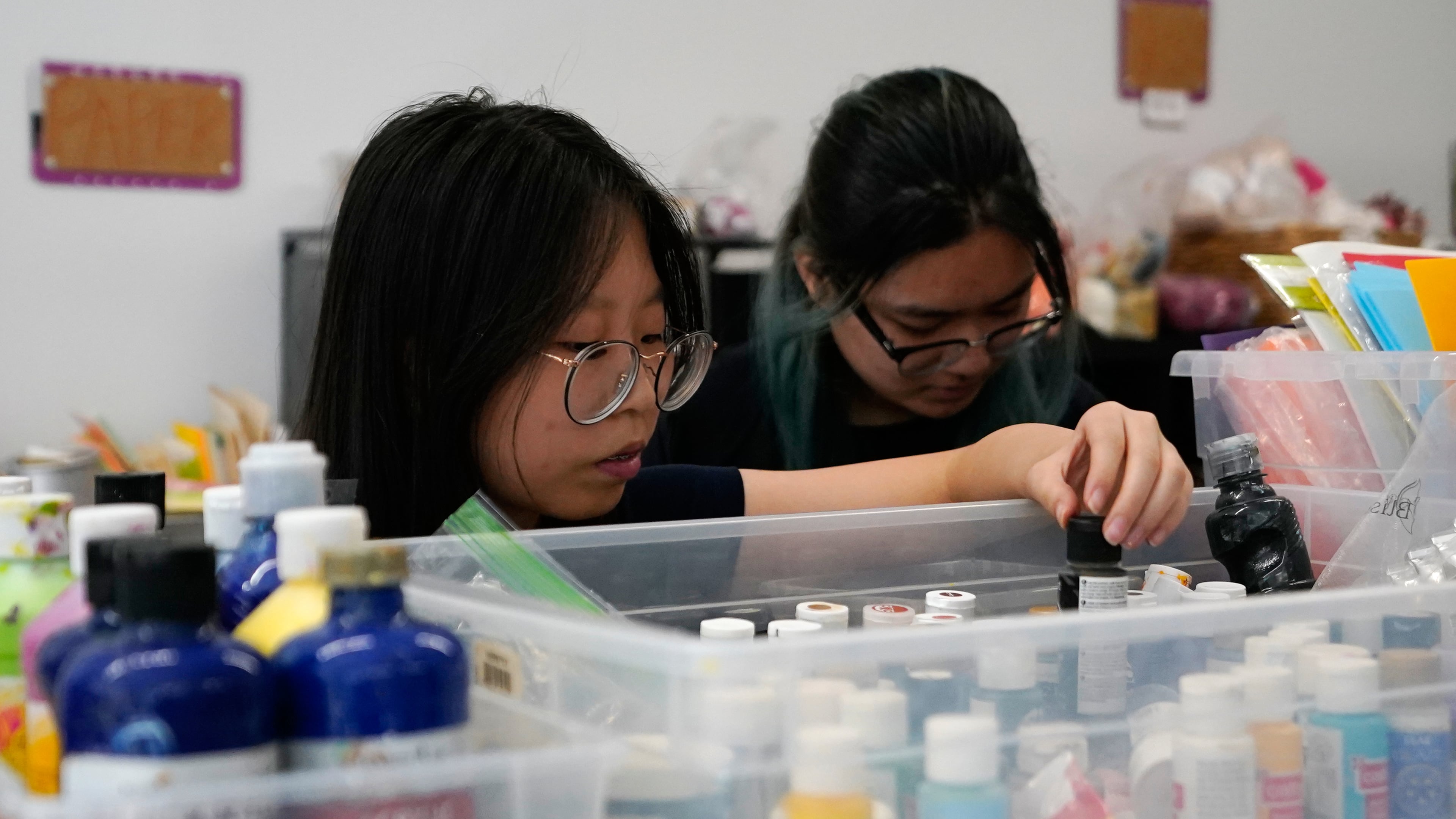 Shoppers look through art supplies for sale at the Brooklyn Creative Reuse on Wednesday, July 29, 2026, in the Brooklyn borough of New York. (AP Photo/Alyssa Goodman)
