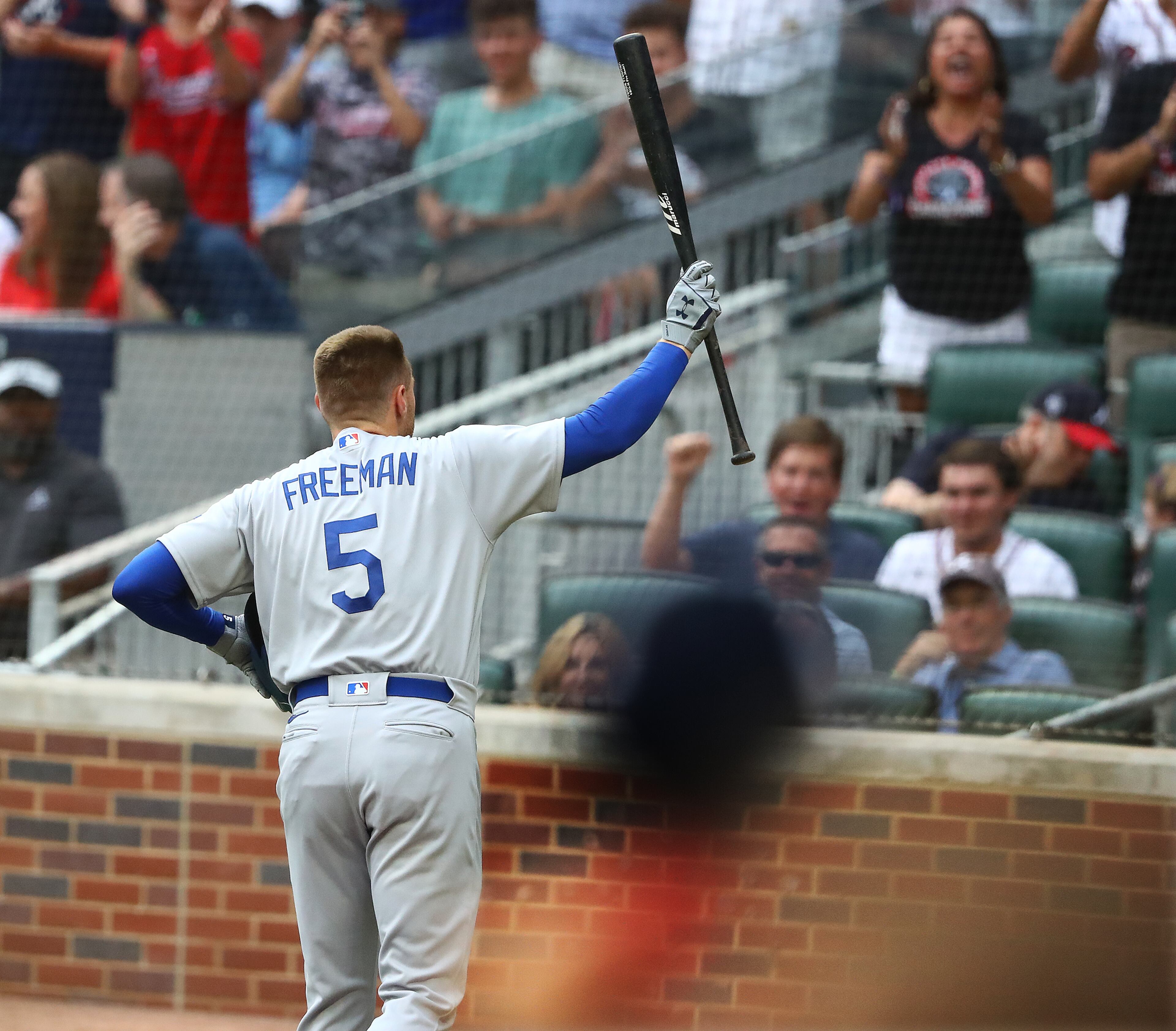 Former Braves first baseman Freddie Freeman steps away from the plate to thank cheering fans as he bats in the first inning for the Dodgers on Sunday in Atlanta. (Curtis Compton / Curtis.Compton@ajc.com)