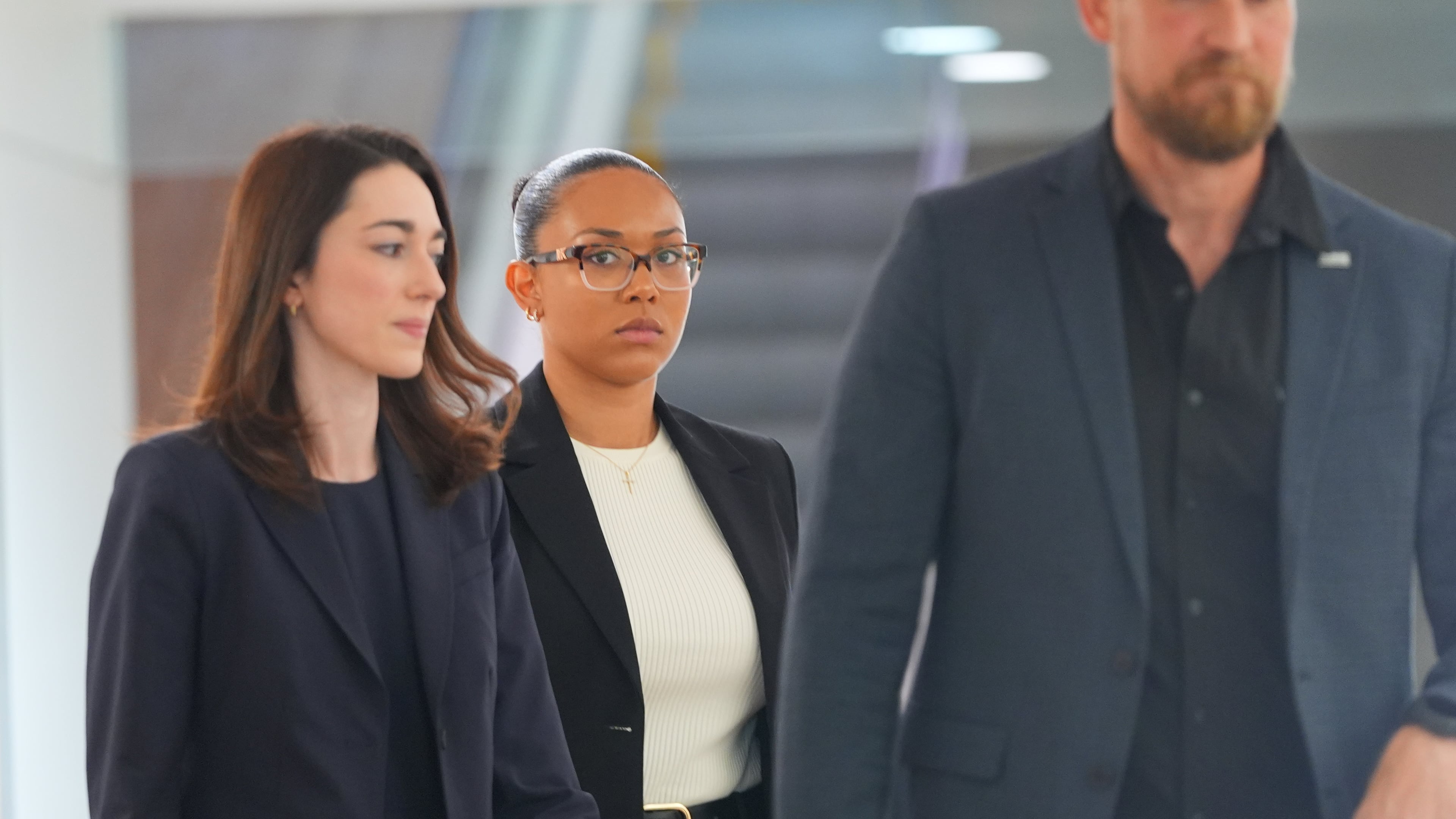 McKenna West, center, walks in a hallway before a court hearing in Dallas, Tuesday, Aug. 25, 2026. (AP Photo/LM Otero)