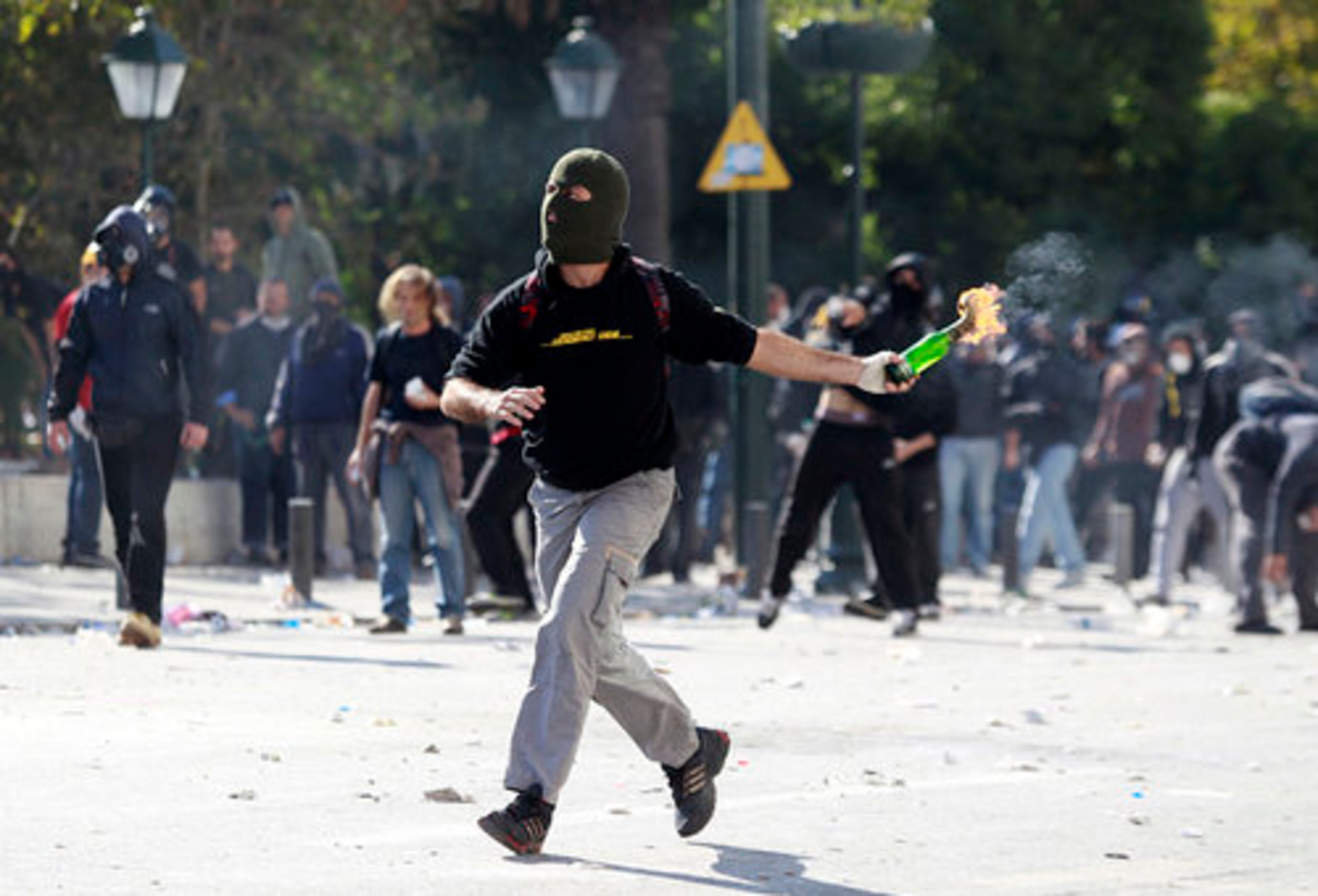 A protester prepares to toss a Molotov cocktail.