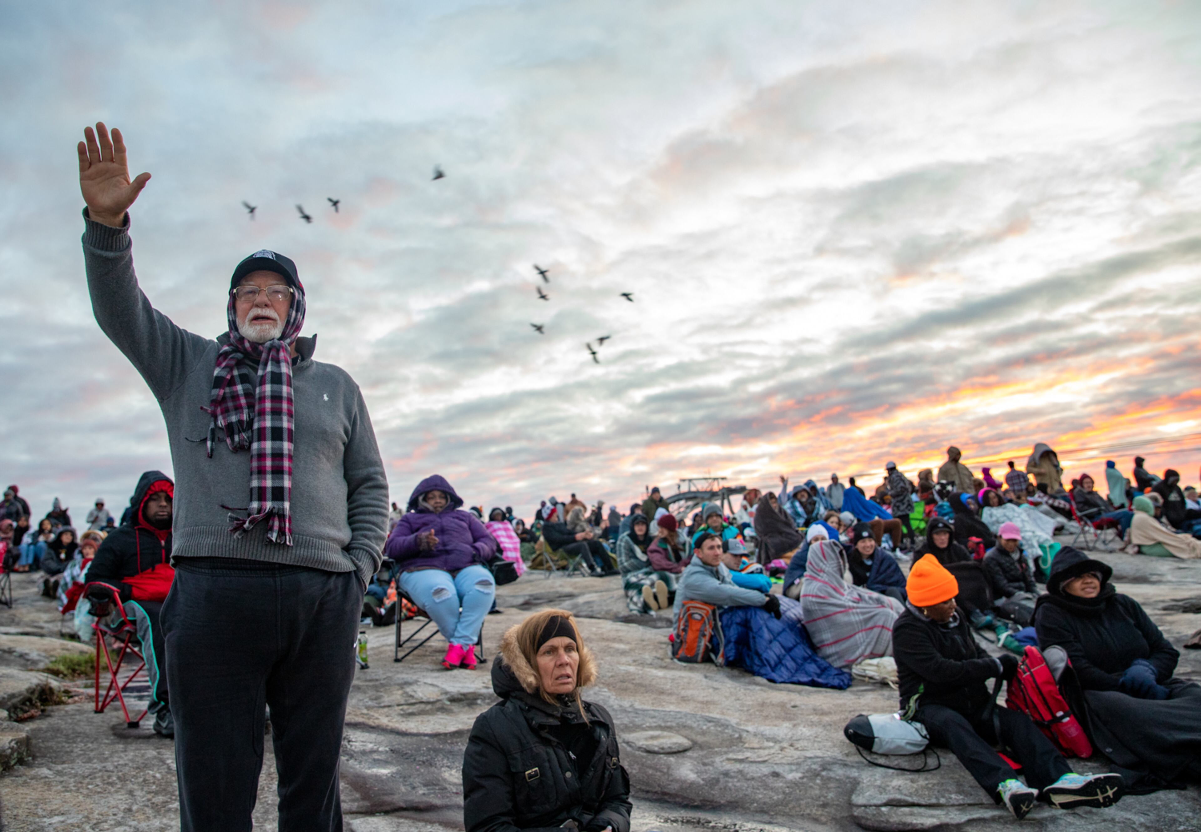 Worshippers, including Frank Fore, gather atop Stone Mountain for the annual Easter sunrise service despite 40 degree weather and 25 mph winds Sunday, April 9, 2023. (Photo: Jenni Girtman for The Atlanta Journal-Constitution)