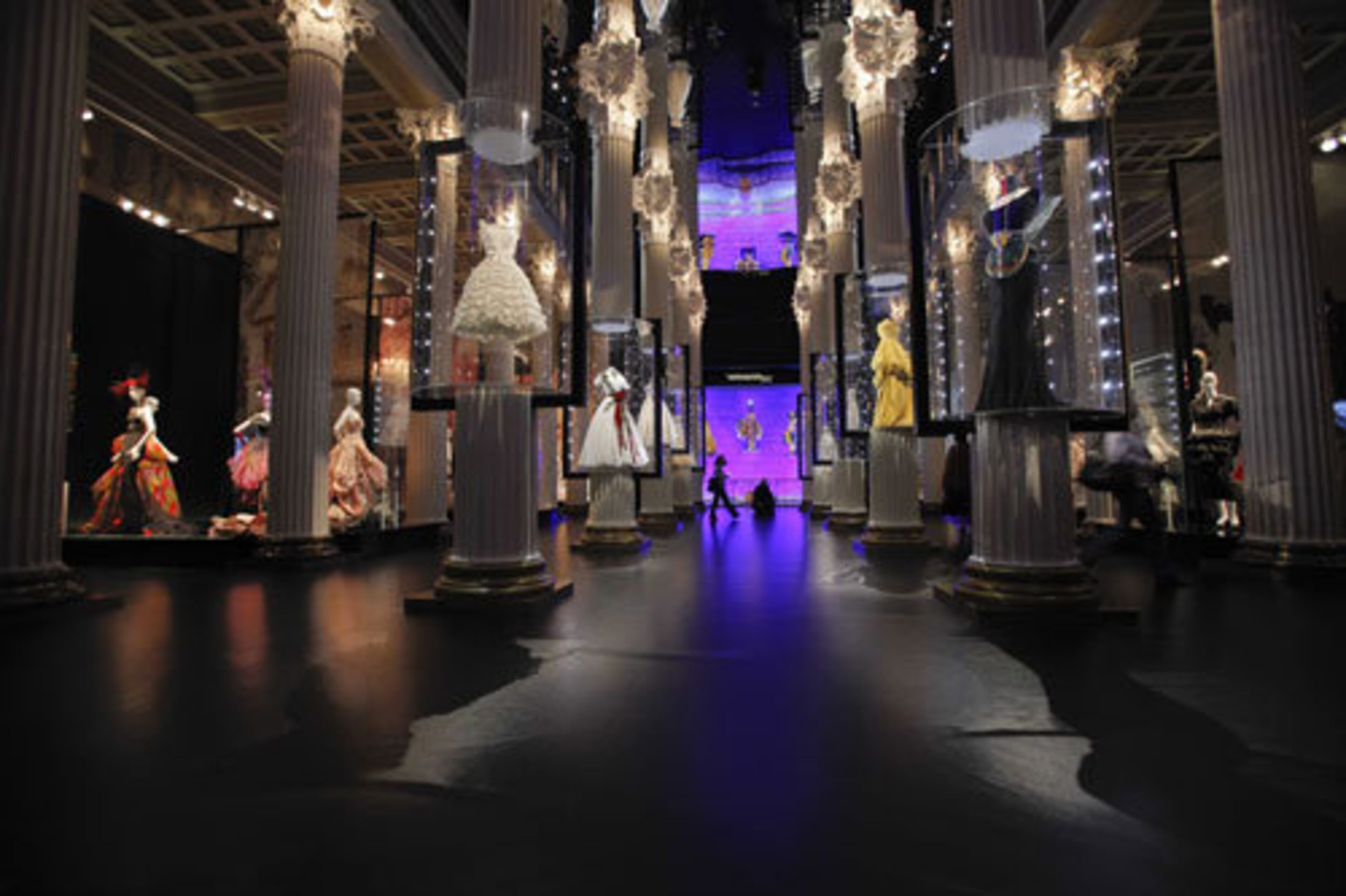 Gowns hang on display from the museum ceilings.