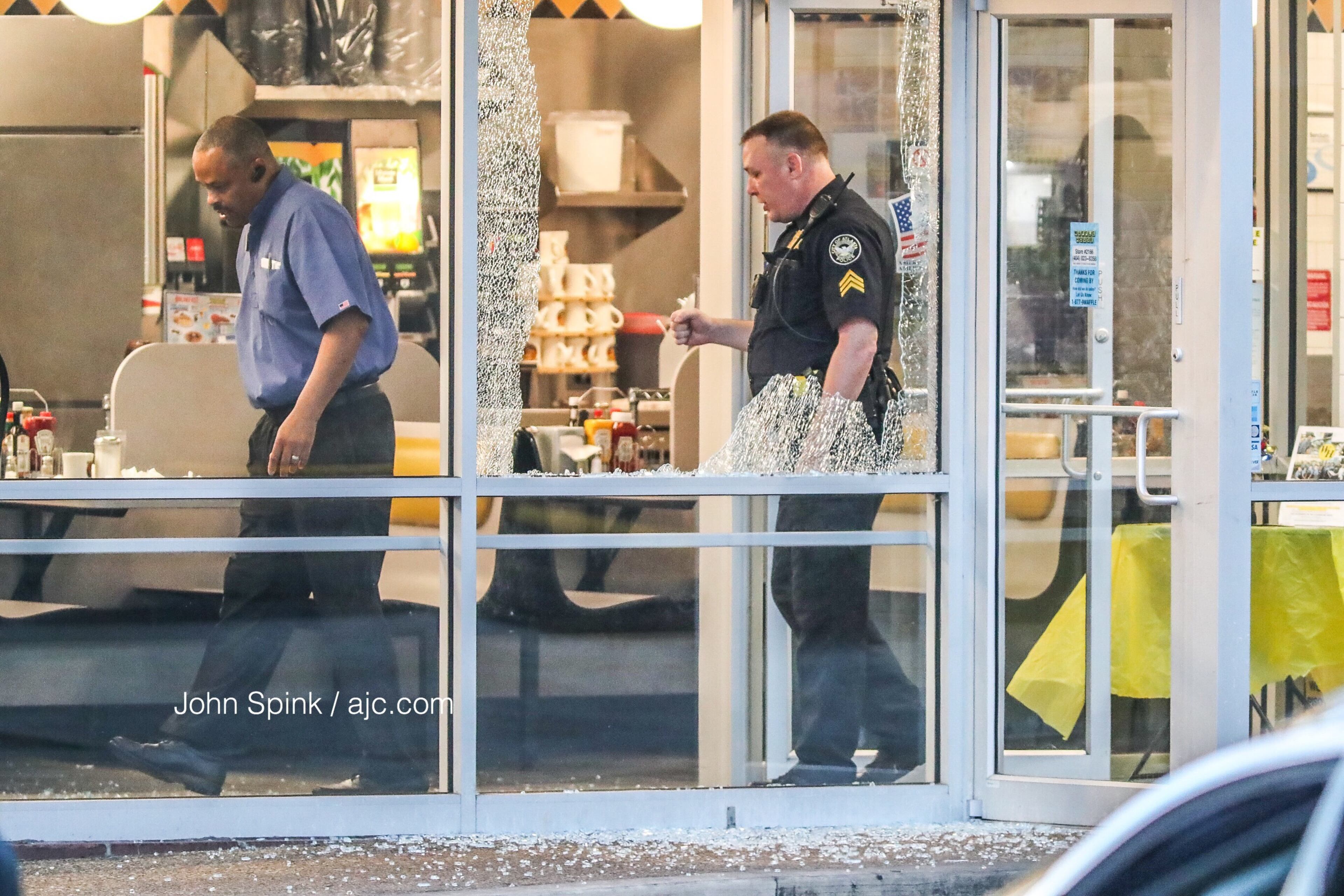 Glass is shattered near the seating area of the Waffle House in the 1000 block of Northside Drive. JOHN SPINK / JSPINK@AJC.COM