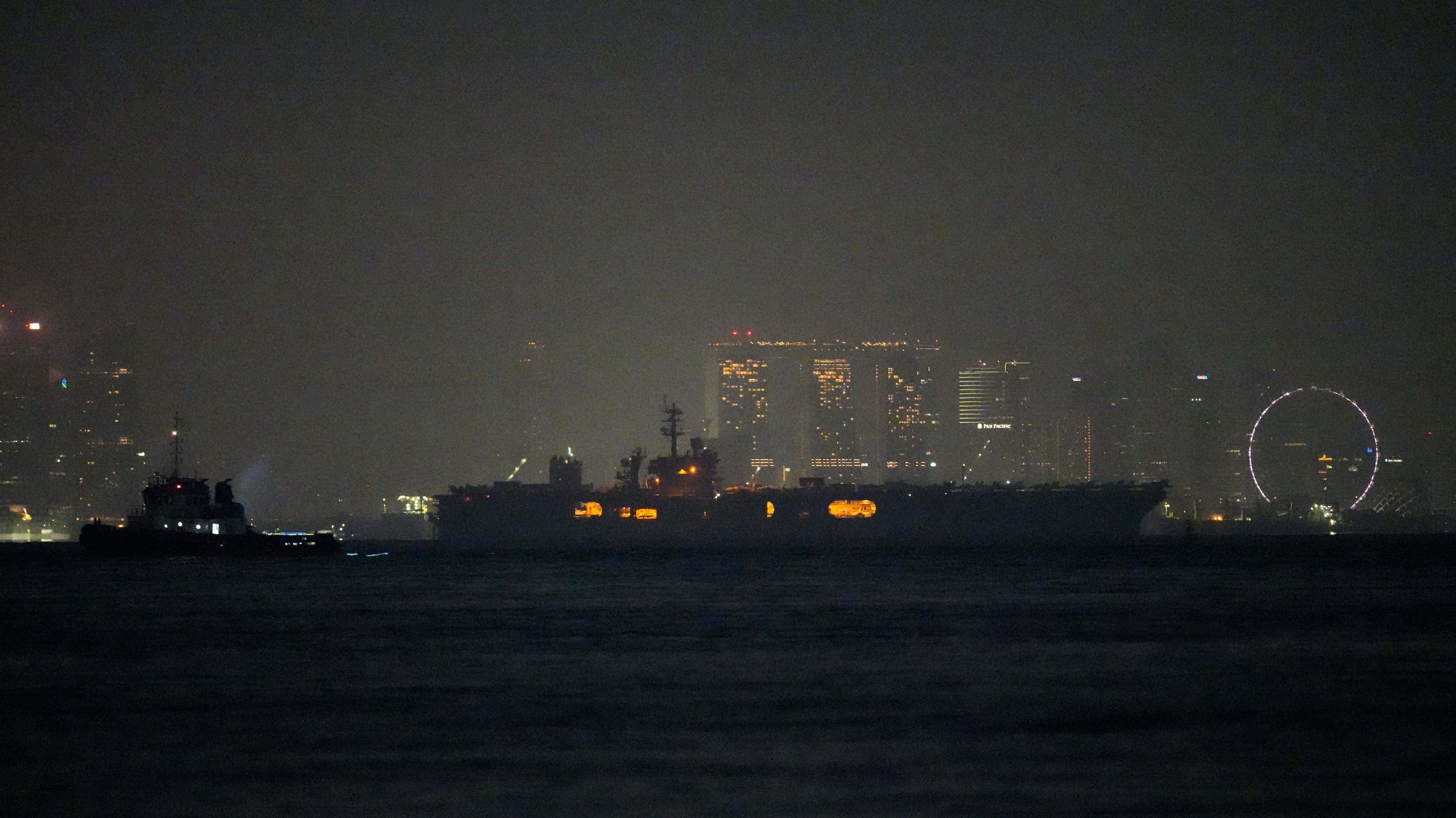 The U.S. Navy aircraft carrier USS Abraham Lincoln sails past Singapore as seen from Batam, Indonesia, Sunday, Aug. 30, 2026. (AP Photo/Dita Alangkara)