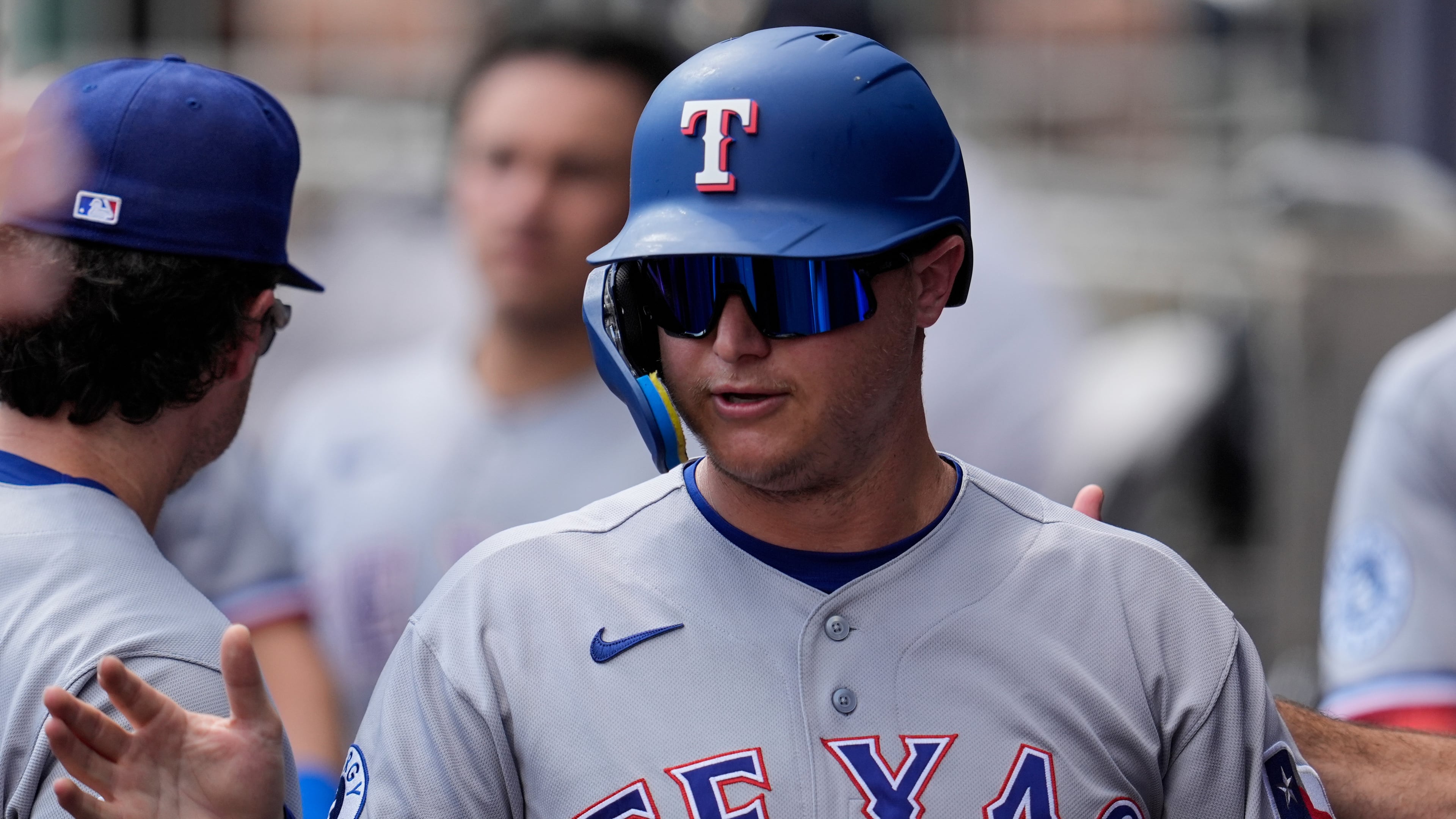 Texas Rangers designated hitter Joc Pederson (3) celebrates scoring off the bat of Brandon Nimmo in the third inning of a baseball game against the Atlanta Braves, Saturday, July 18, 2026, in Atlanta. (AP Photo/Mike Stewart)