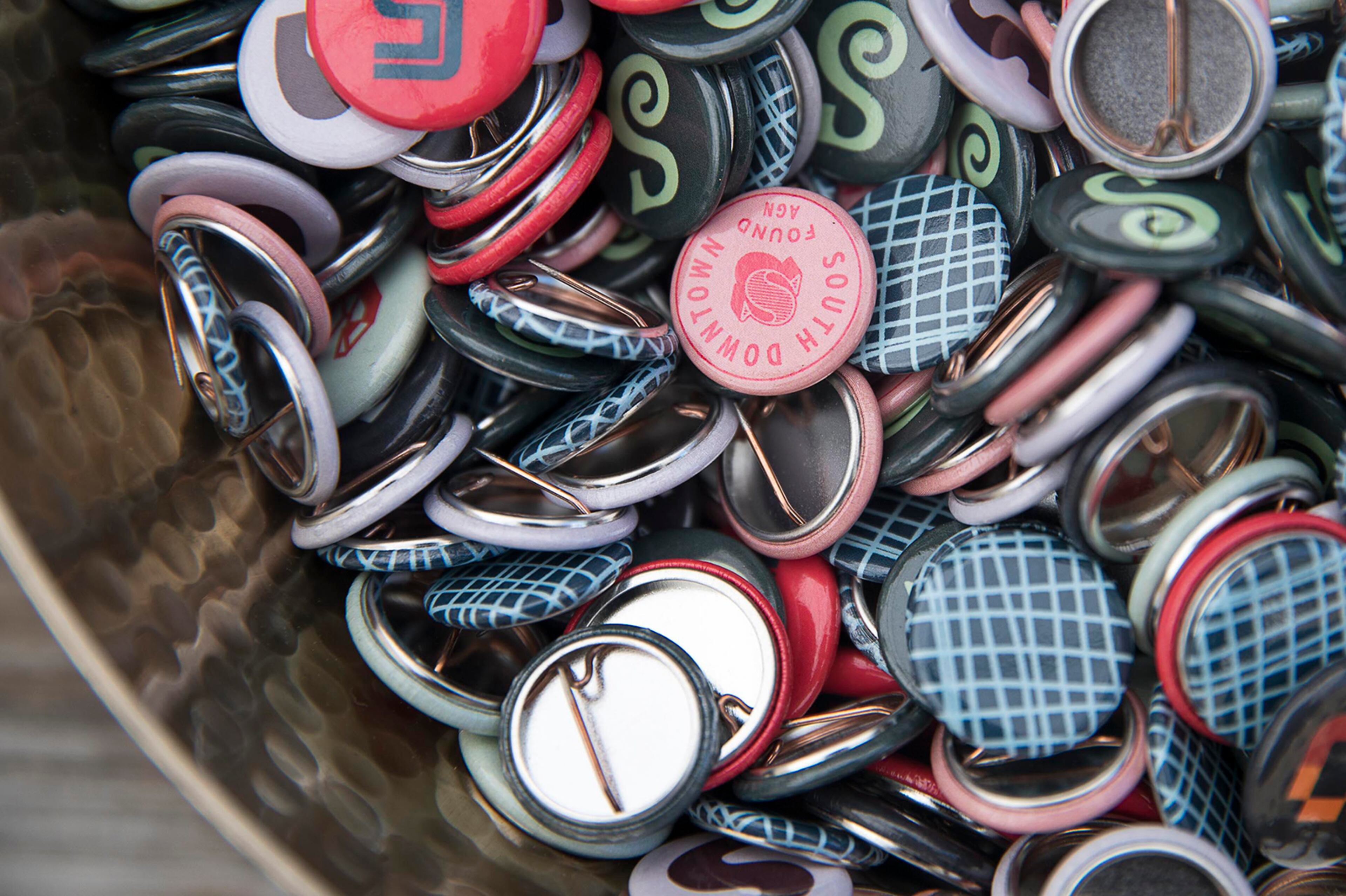 04/11/2019 -- Atlanta, Georgia --Decorative "South Dwntn" buttons are displayed during a "Pop-Up Row" shopping event along the 200 block of Mitchell Street SW in Atlanta's South Downtown community, Thursday, April 11, 2019. (ALYSSA POINTER/ALYSSA.POINTER@AJC.COM)