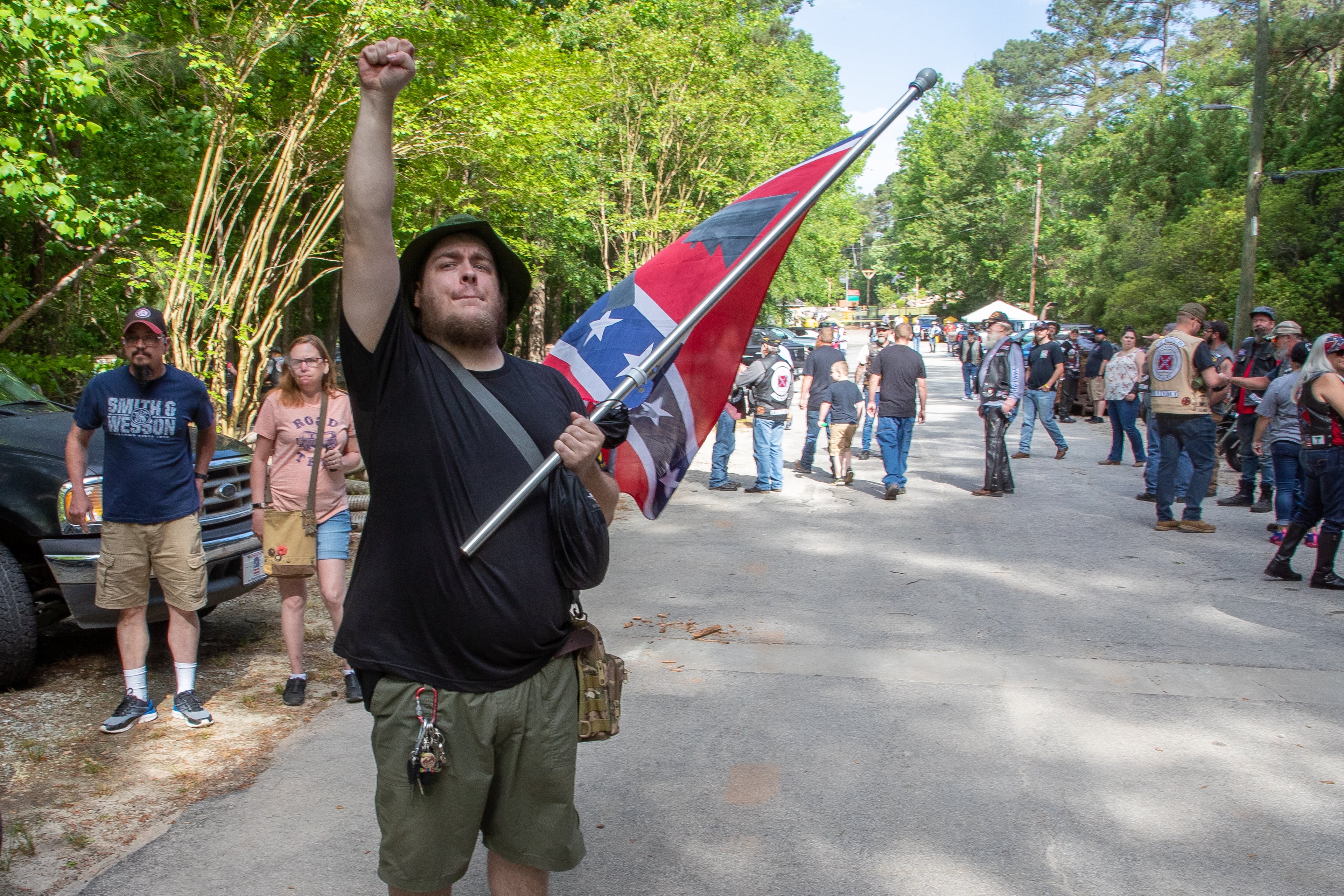 Edward Rychlik salutes as a truck pulling a Civil War-era cannon drives by before the start of the Sons of Confederate Veterans rally in Stone Mountain Park on Saturday, April 30, 2022. (Steve Schaefer / steve.schaefer@ajc.com)