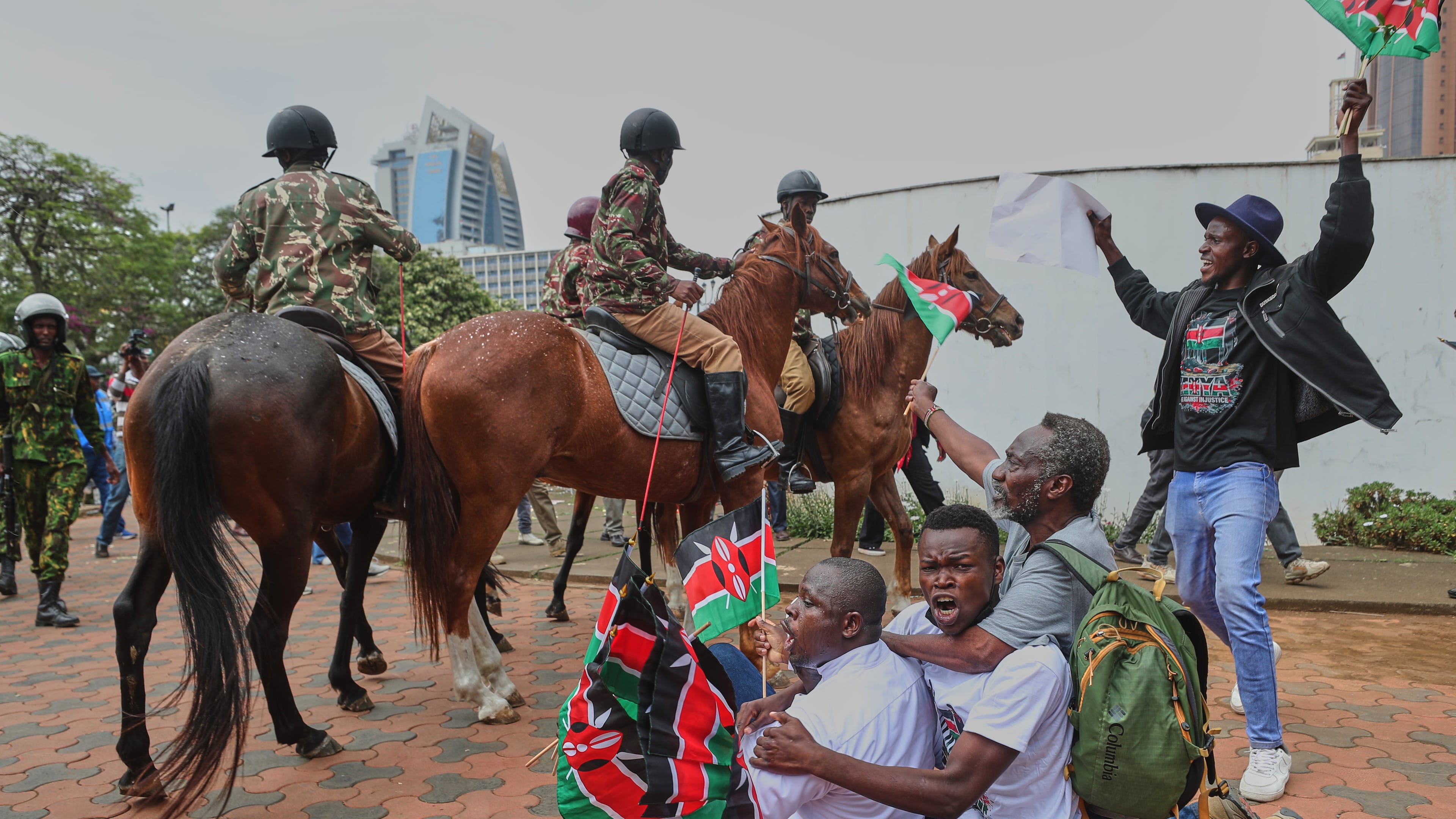 Protesters sing and wave Kenyan flags near Parliament during a demonstration marking two years since the 2024 anti-government protests in Nairobi, Kenya, Thursday, June 25, 2026. (AP Photo/Henry Naminde)