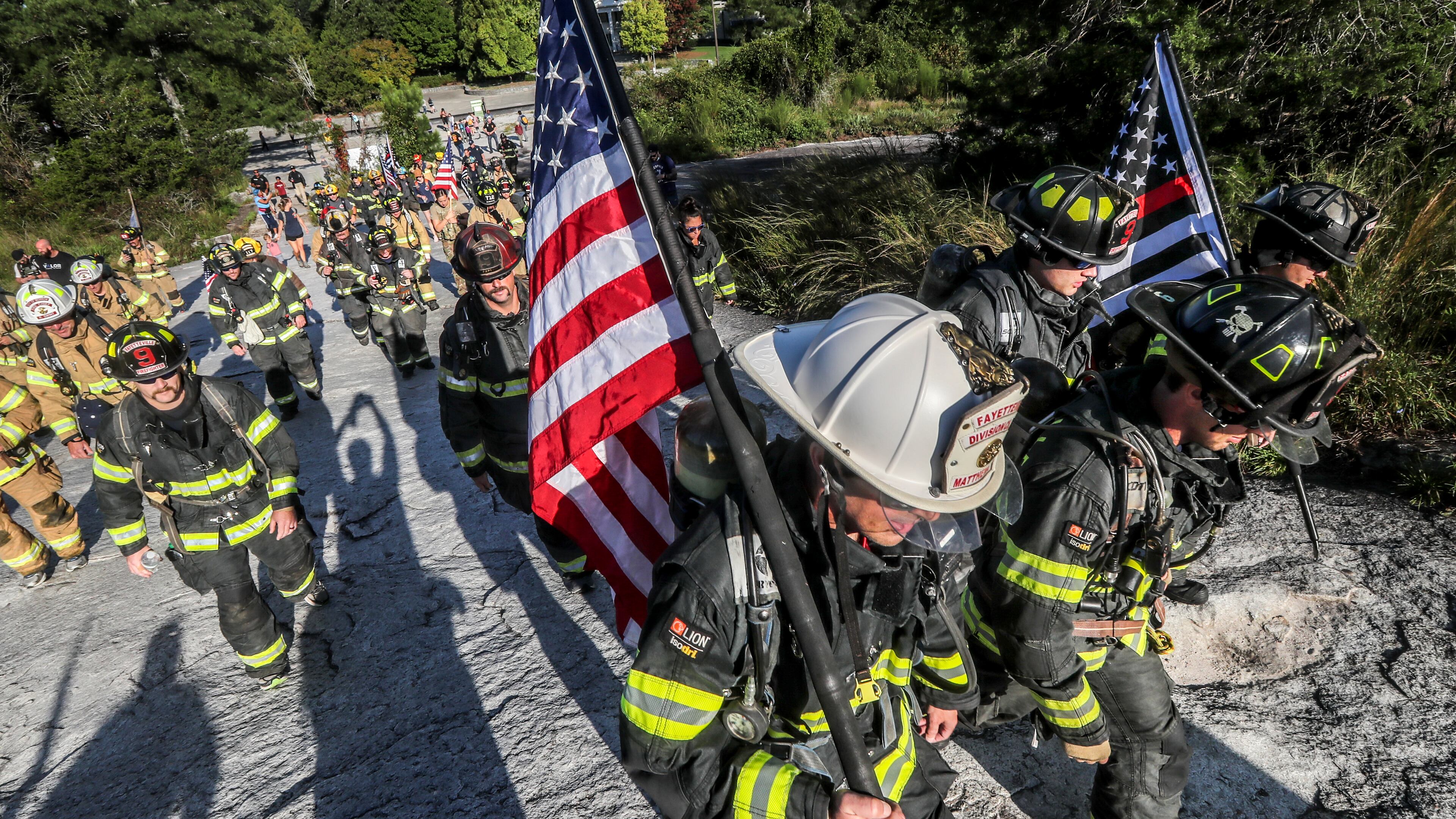 Wearing full firefighting gear, about 200 metro Atlanta area firefighters honored the firefighters, paramedics and law enforcement officers who lost their lives on Sept. 11, 2001, by ascending Stone Mountain in 2001. (John Spink / AJC FILE PHOTO)