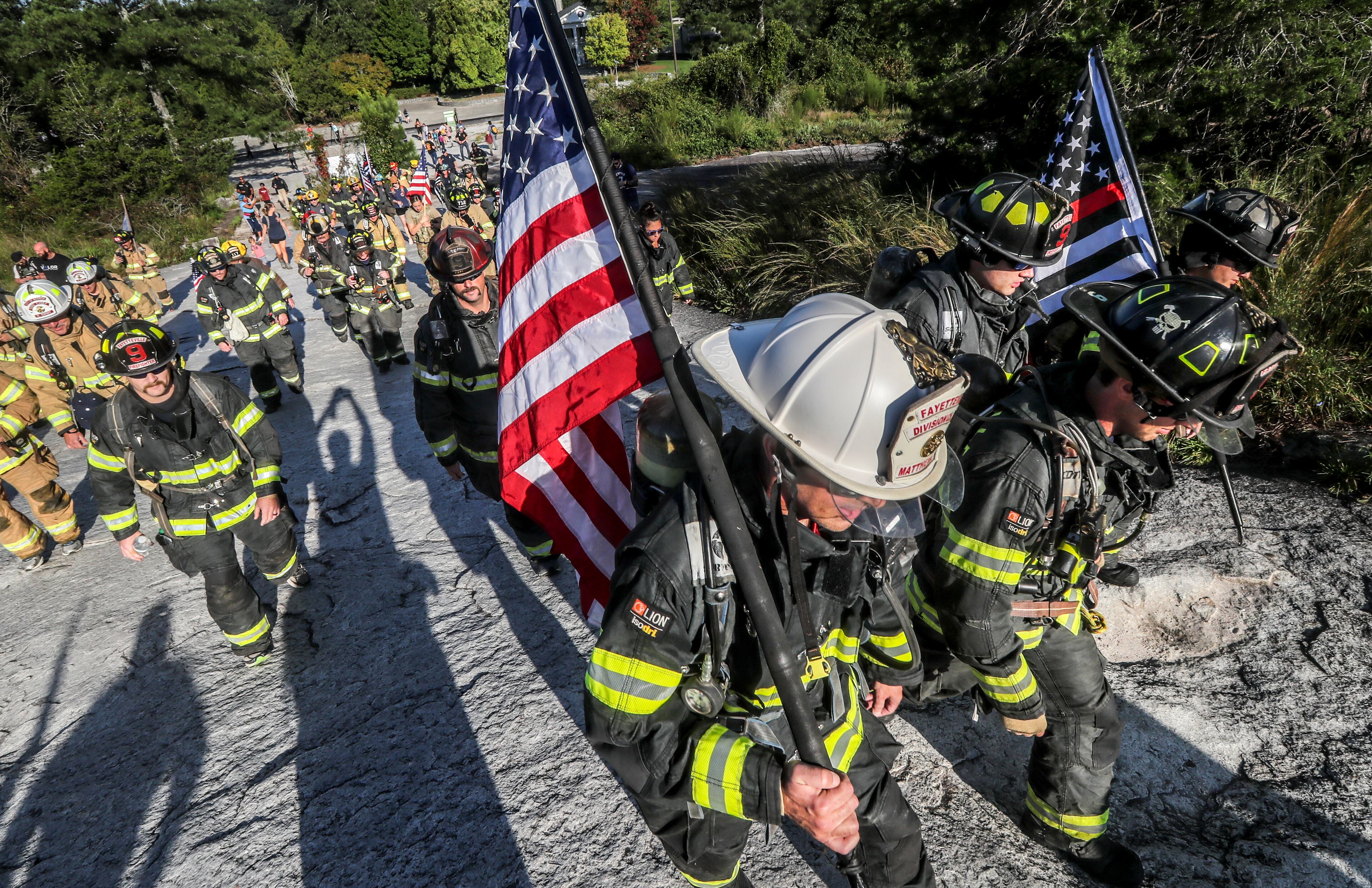 September 10, 2021 Stone Mountain: Wearing a full turnout firefighting gear, some 200 metro Atlanta area firefighters honored the 343 firefighters and paramedics, and 72 law enforcement officers who lost their lives on Sept. 11, 2001 by ascending Stone Mountain on Friday, September 10, 2021. The City of Fayetteville Fire Department who sponsors the annual event for the one-mile climb that is equivalent to 160 flights of stairs has seen the event grow every year that also includes police and military participants. Numerous events are scheduled Saturday around the metro area to observe the 20th anniversary of the terror attacks on Sept. 11, 2001. (John Spink / John.Spink@ajc.com)