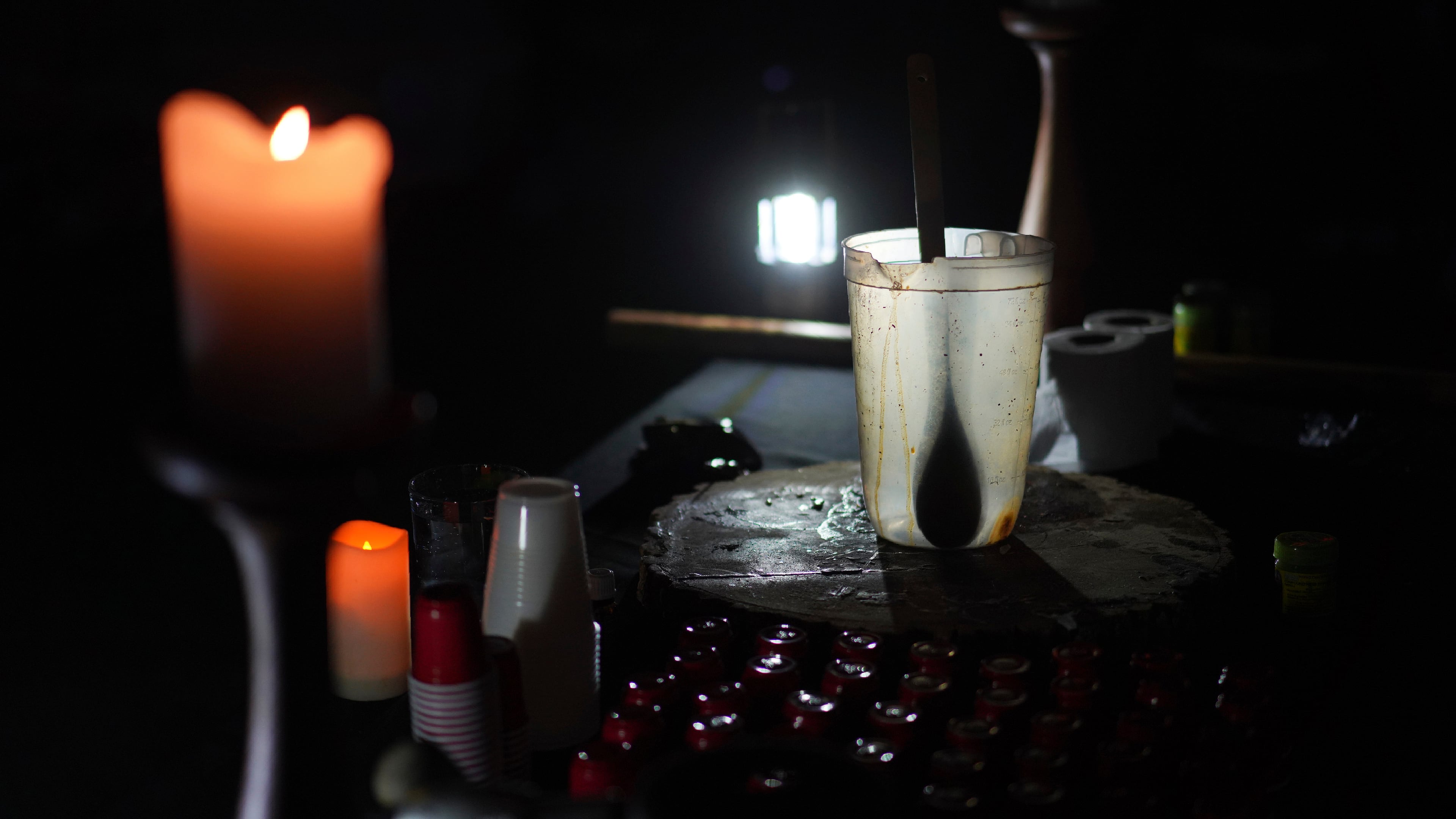 FILE - An empty pitcher and shot sized cups sit on an altar during an ayahuasca ceremony at a retreat in Hildale, Utah, Oct. 14, 2022. (AP Photo/Jessie Wardarski, File)