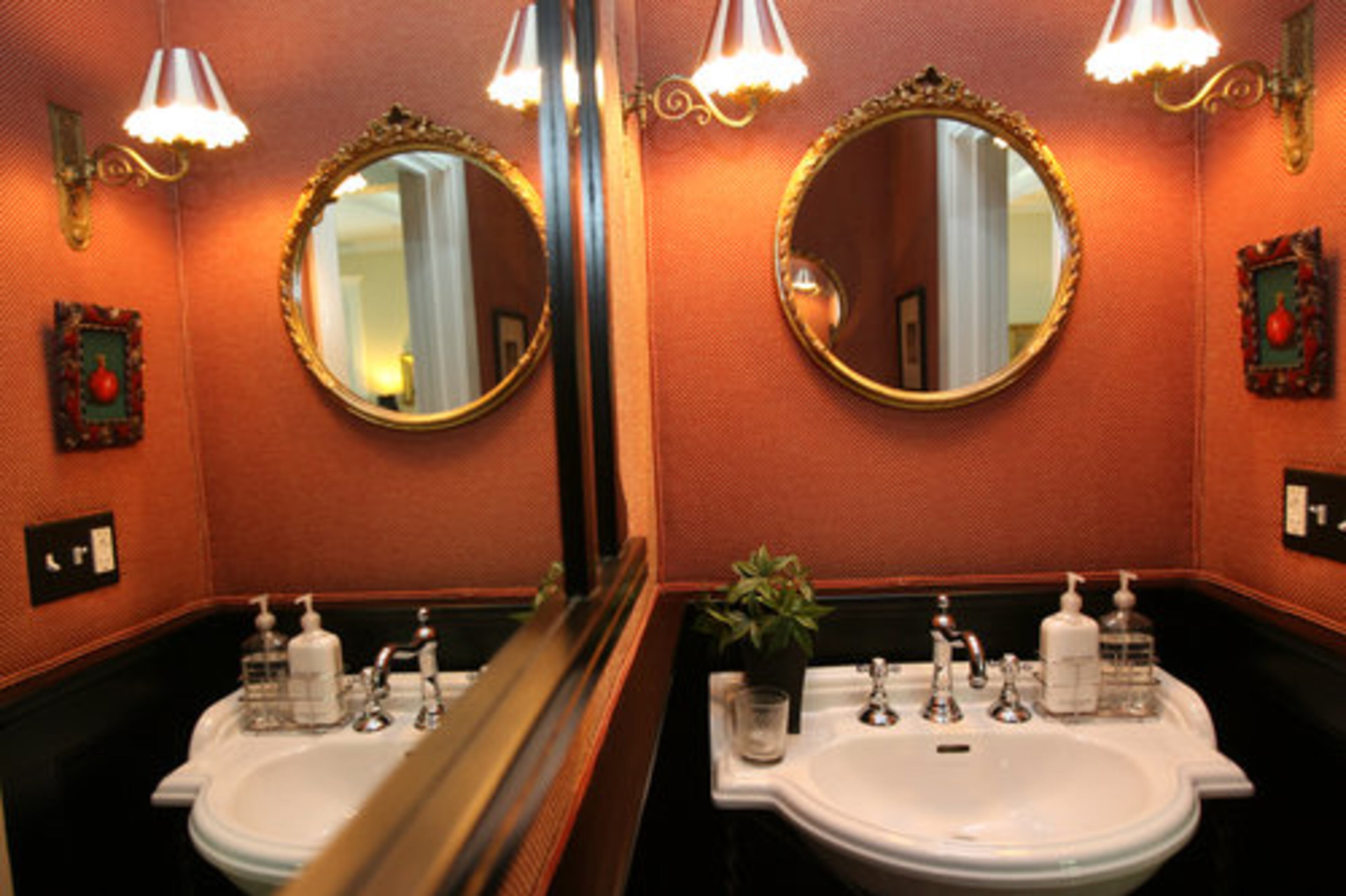 The downstairs half bathroom is decorated in brightly colored walls.