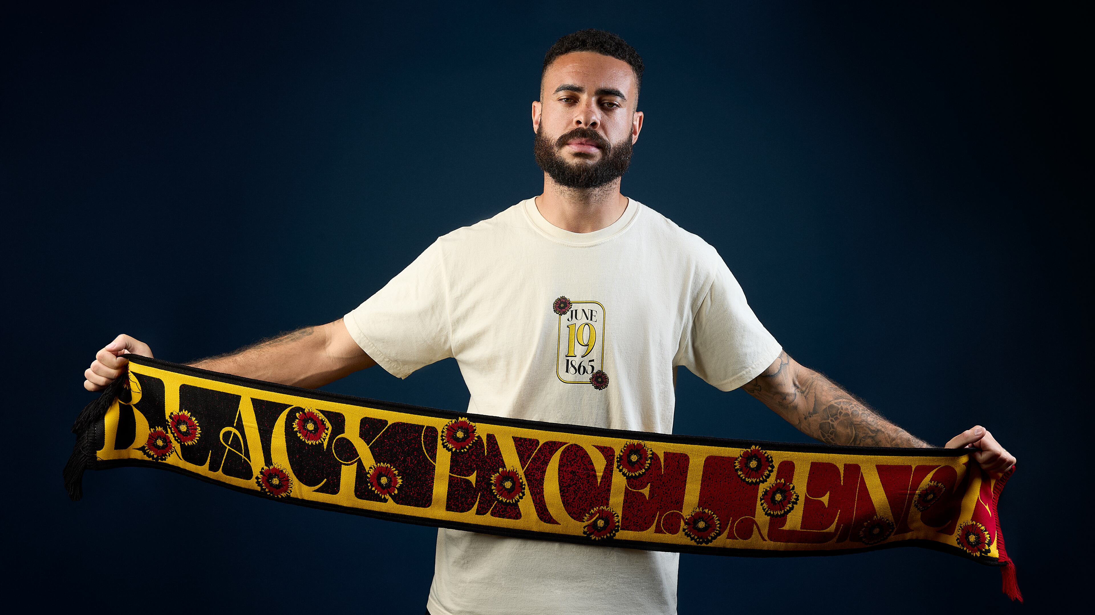 Atlanta United’s Derrick Williams unfurls the team’s Juneteenth scarf, which is part of the Legacy Collection.