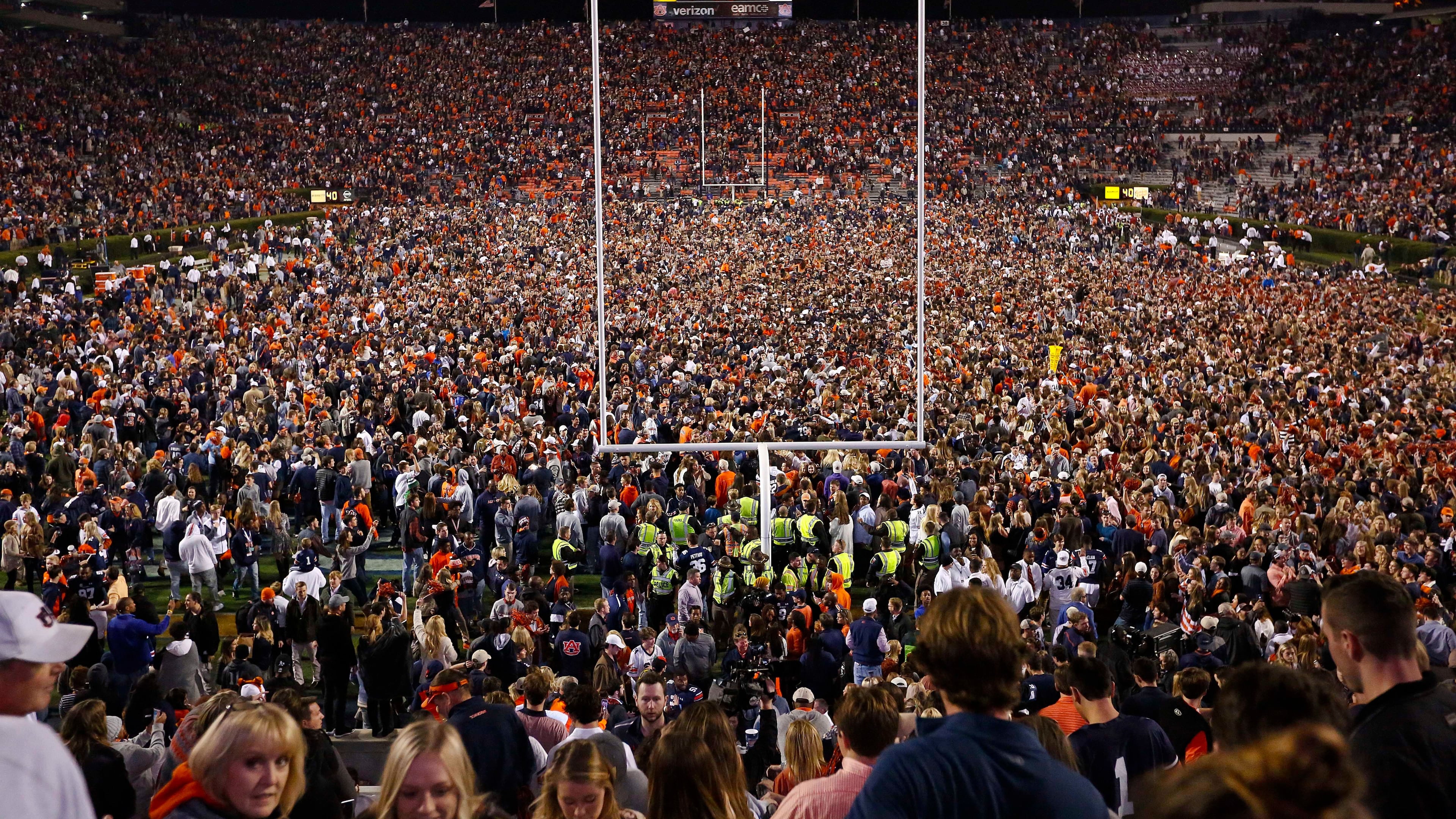 Fans rush the field after Auburn defeated Alabama in the Iron Bowl.