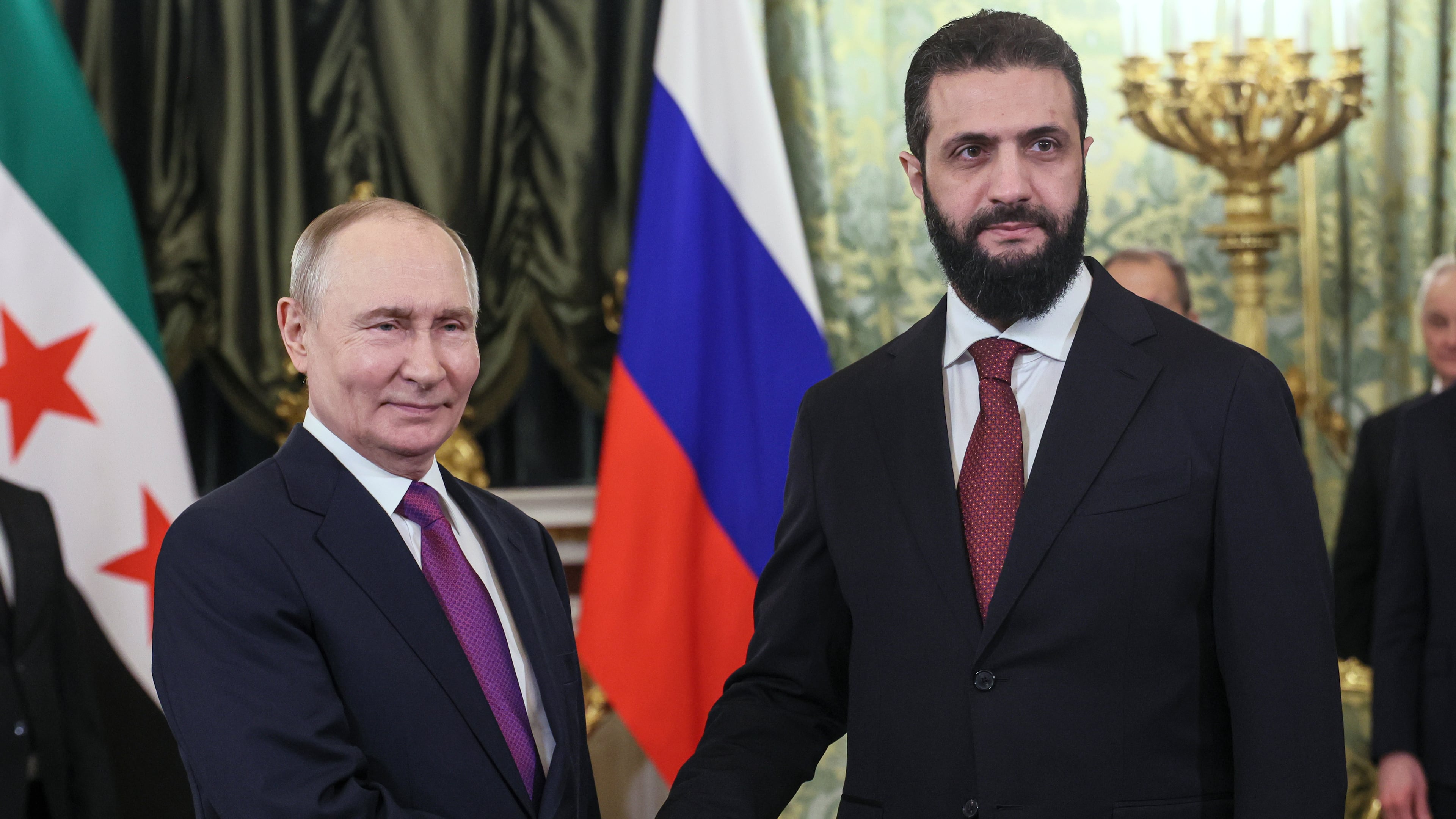 Russian President Vladimir Putin, left, and Syrian interim President Ahmad al-Sharaa pose for a photo during their meeting at the Grand Kremlin Palace in Moscow, on Wednesday, Jan. 28, 2026. (Maxim Shipenkov/Pool Photo via AP)