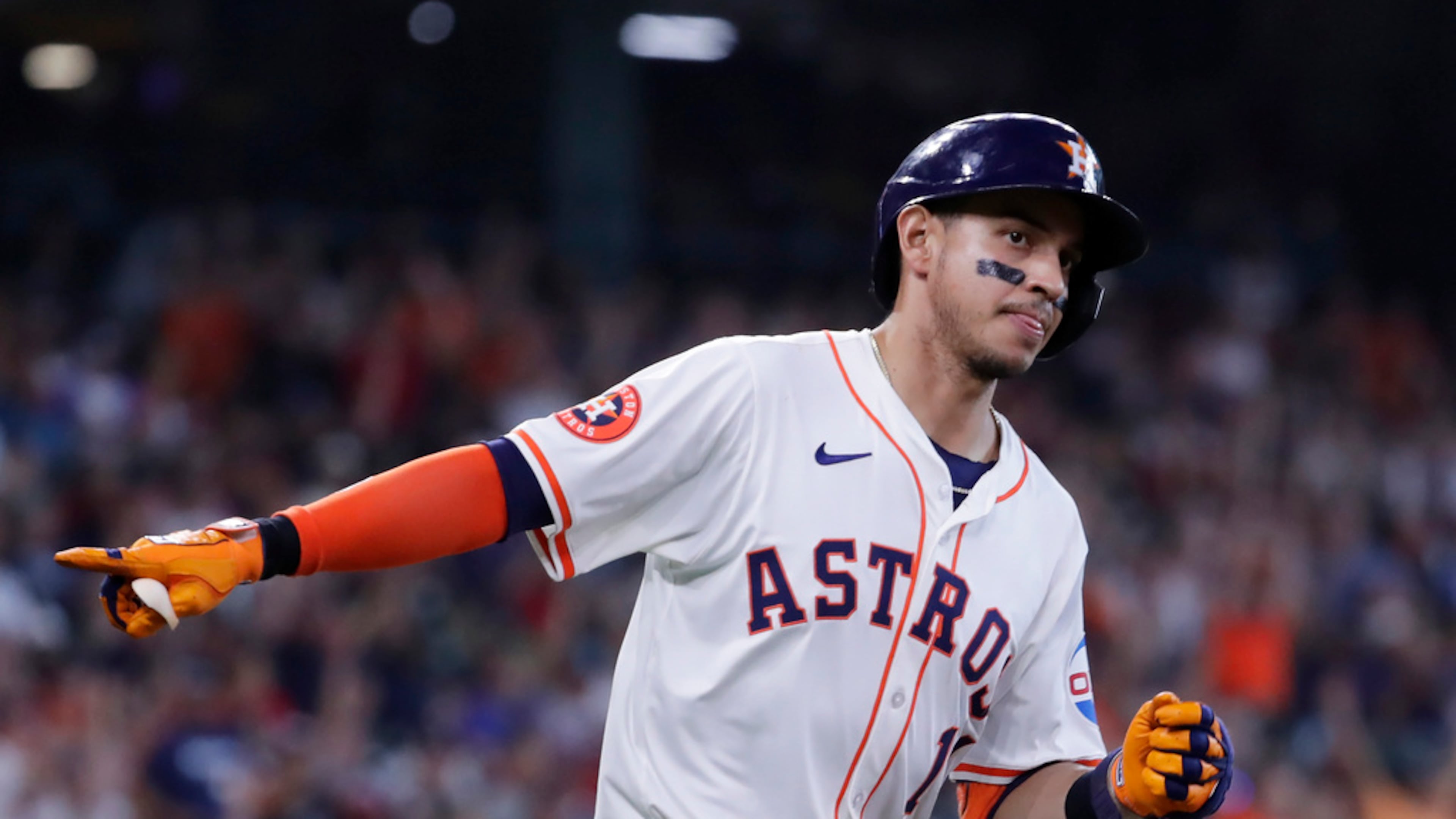 Houston Astros' Mauricio Dubon points to the dugout in celebration as he rounds the bases after hitting a home run against the Atlanta Braves during the sixth inning of a baseball game Wednesday, April 17, 2024, in Houston. (AP Photo/Michael Wyke)