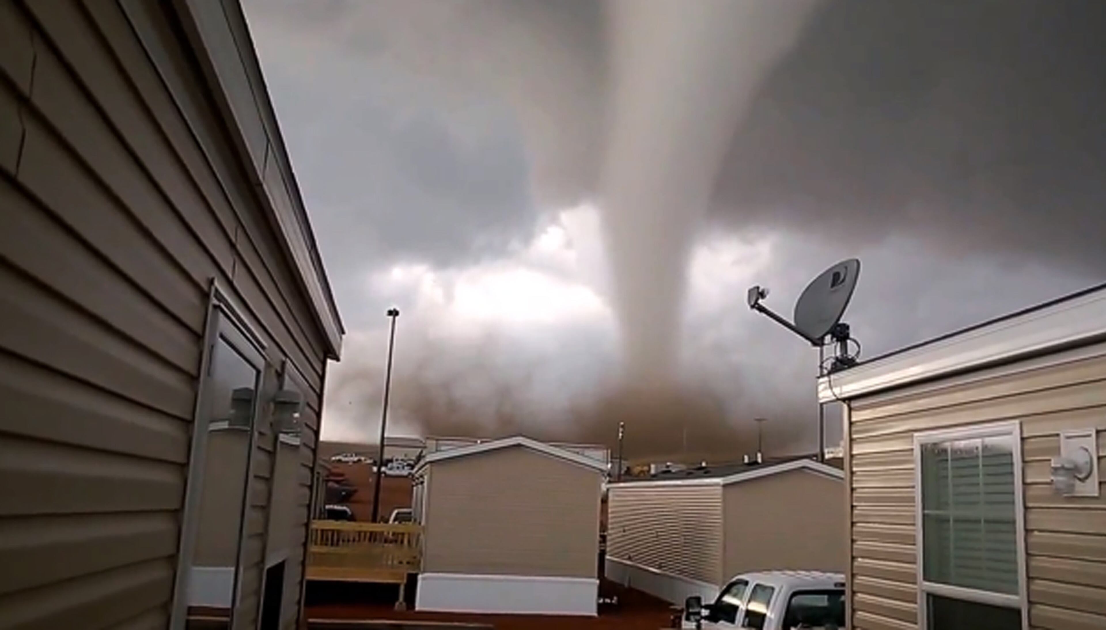 This Monday, May 26, 2014 photo from video provided by Dan Yorgason, shows a tornado in a worker's camp near Watford City, N.D., in the heart of the state's booming oil patch. The tornado injured nine people, including a 15-year-old girl who suffered critical injuries, and damaged or destroyed more than a dozen trailers at the camp. (AP Photo/Dan Yorgason)