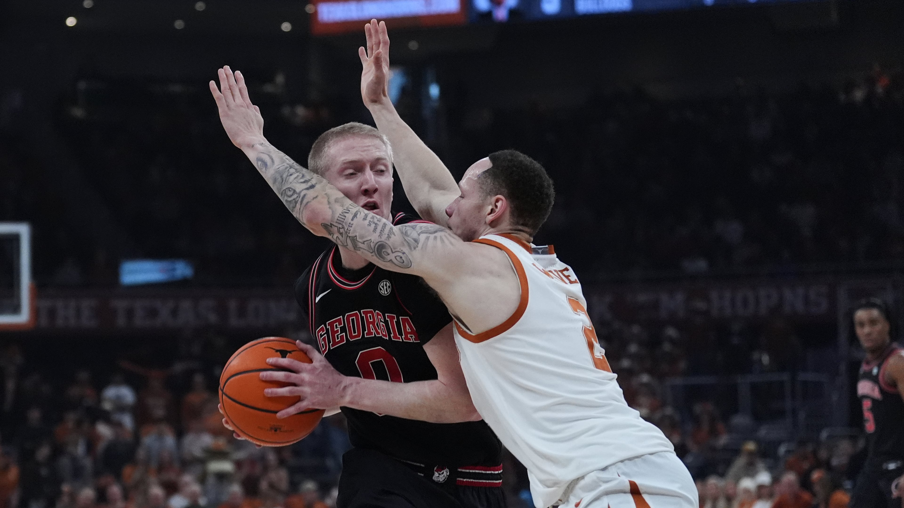 Georgia guard Blue Cain is pressured by Texas guard Chendall Weaver during the first half of an NCAA college basketball game in Austin, Texas, Saturday, Jan. 24, 2026. (Eric Gay/AP)