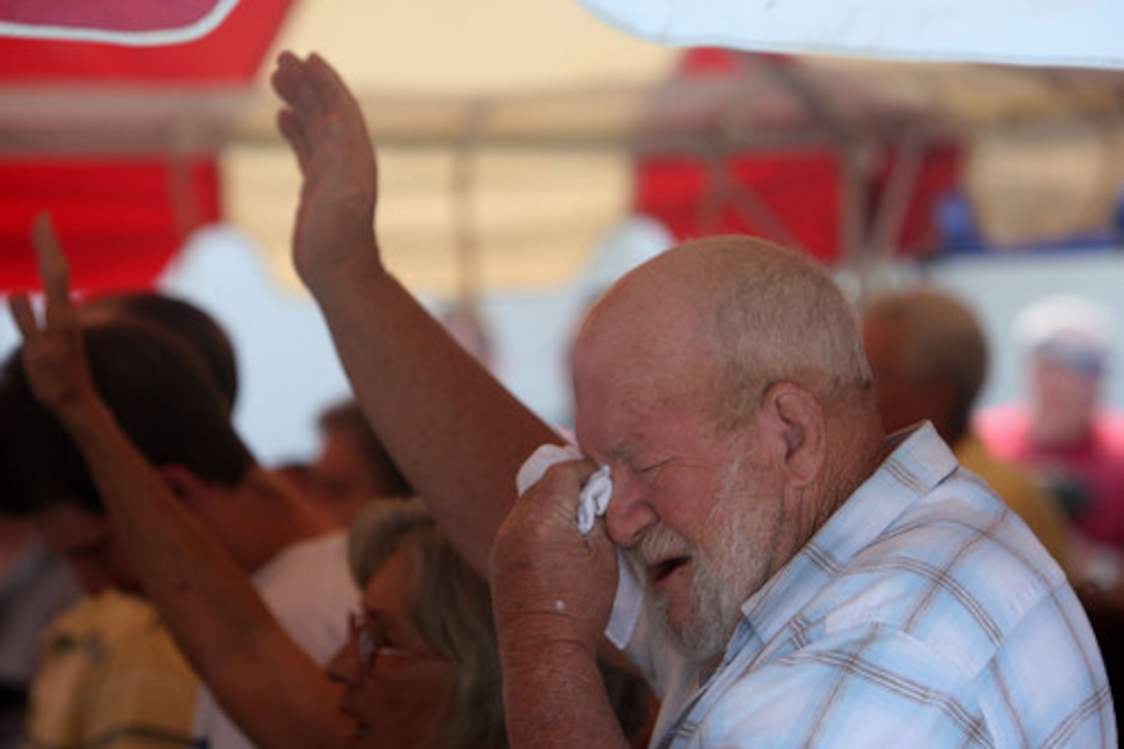 Randall Woodall fights back his emotions during Sunday worship service under a makeshift tent of the parking lot of the Crowe Springs Baptist Church in Cartersville, May 1, 2011. Violent storms turned this North Georgia community upside down last week.