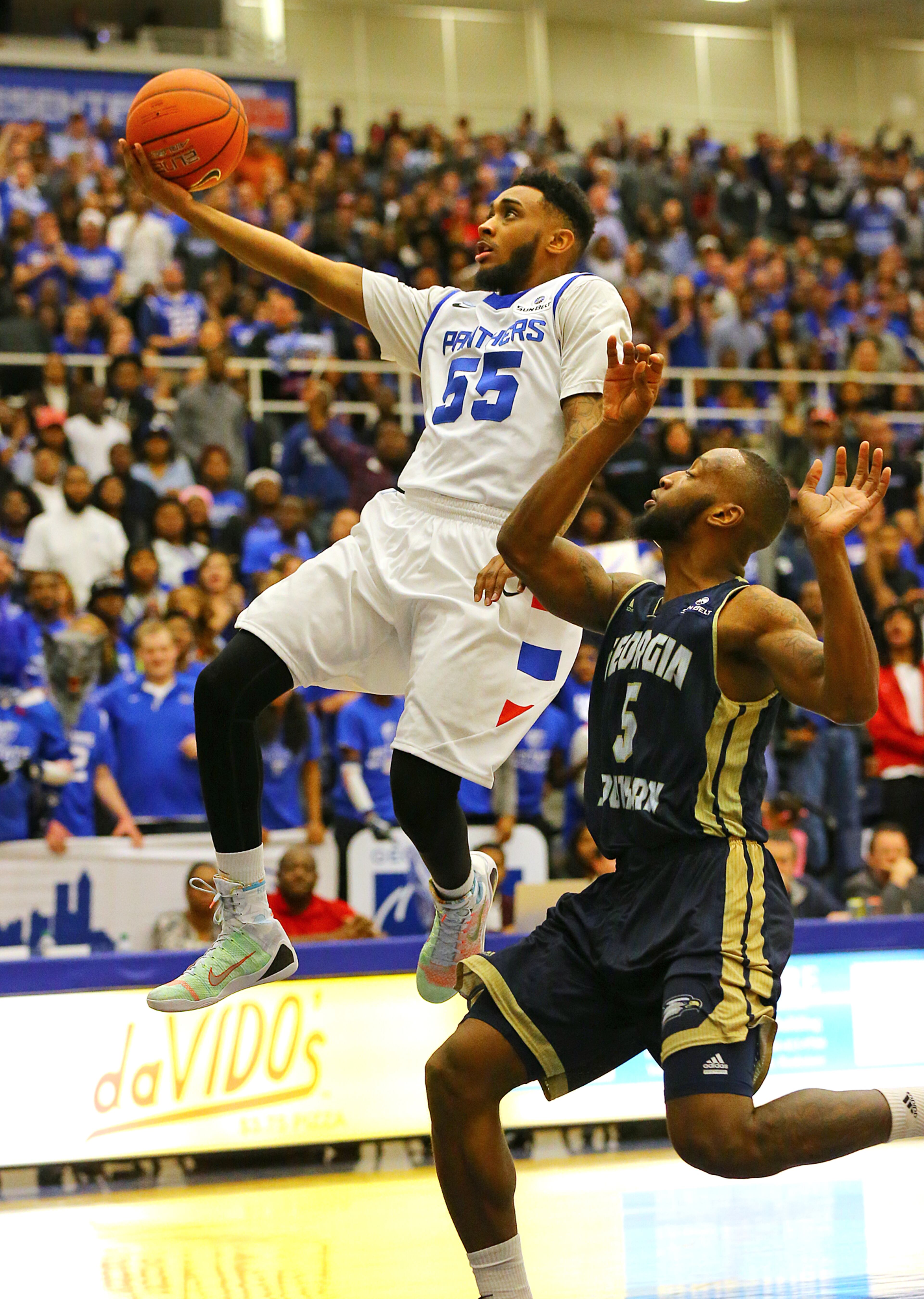 Georgia State guard Ryan Harrow gets past Georgia Southern guard Jelani Hewitt for a layup for two points during a basketball game on Saturday, March 7, 2015, in Atlanta.