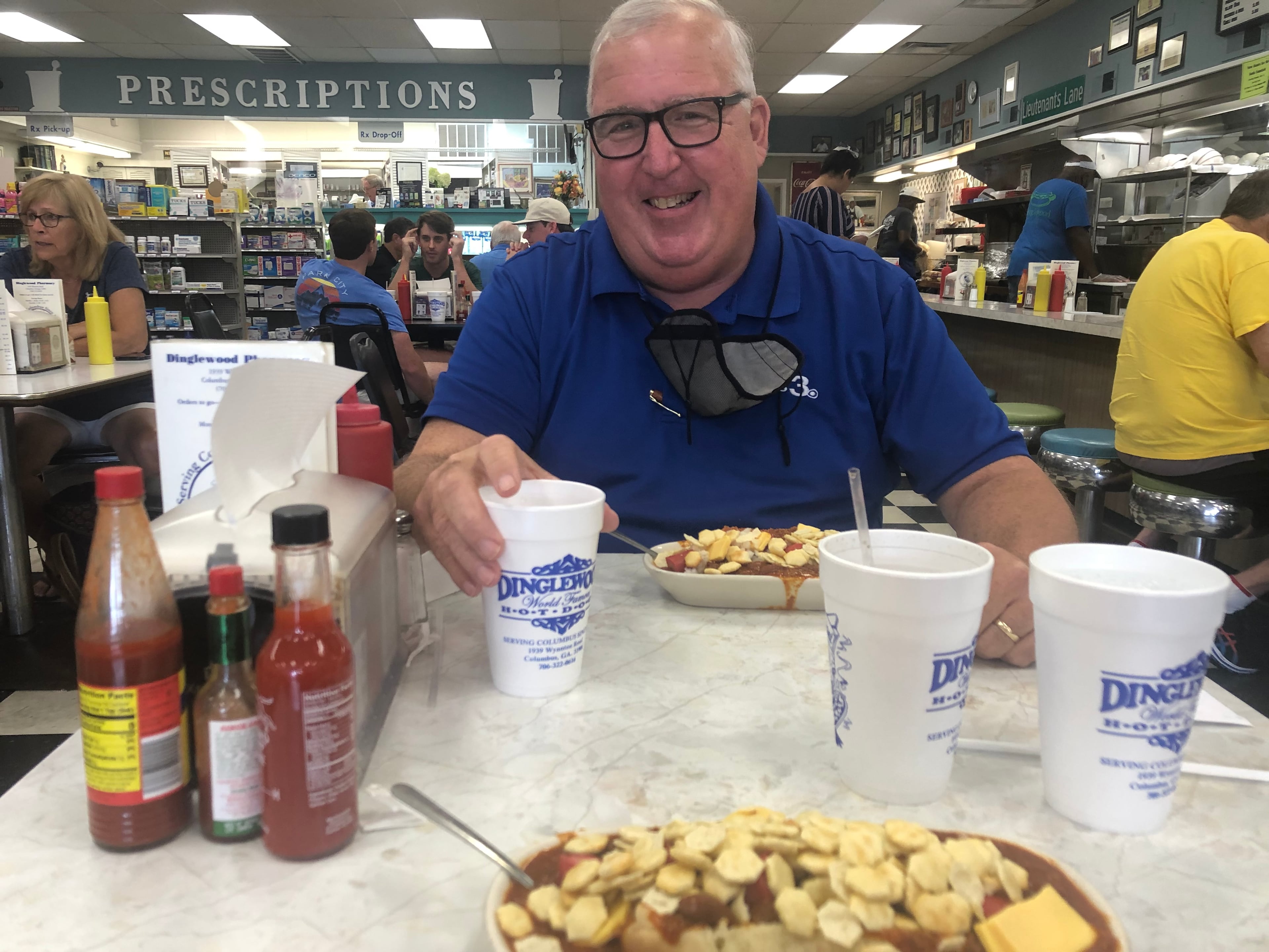 Chuck Williams, a longtime Columbus reporter, and the famous Scrambled Dog lunch at Dinglewood Pharmacy in Columbus. (Patricia Murphy/AJC)