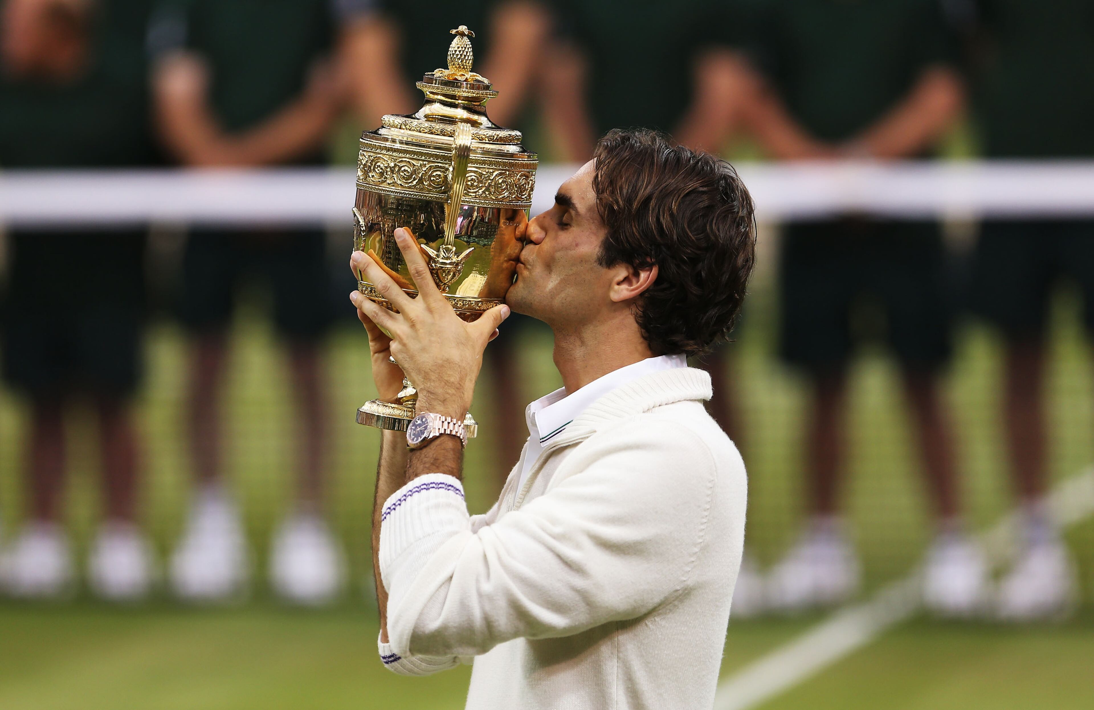 Roger Federer of Switzerland kisses the winner's trophy after winning his Gentlemen's Singles final match against Andy Murray on Day 13 of the Wimbledon Lawn Tennis Championships on July 8, 2012, in London.