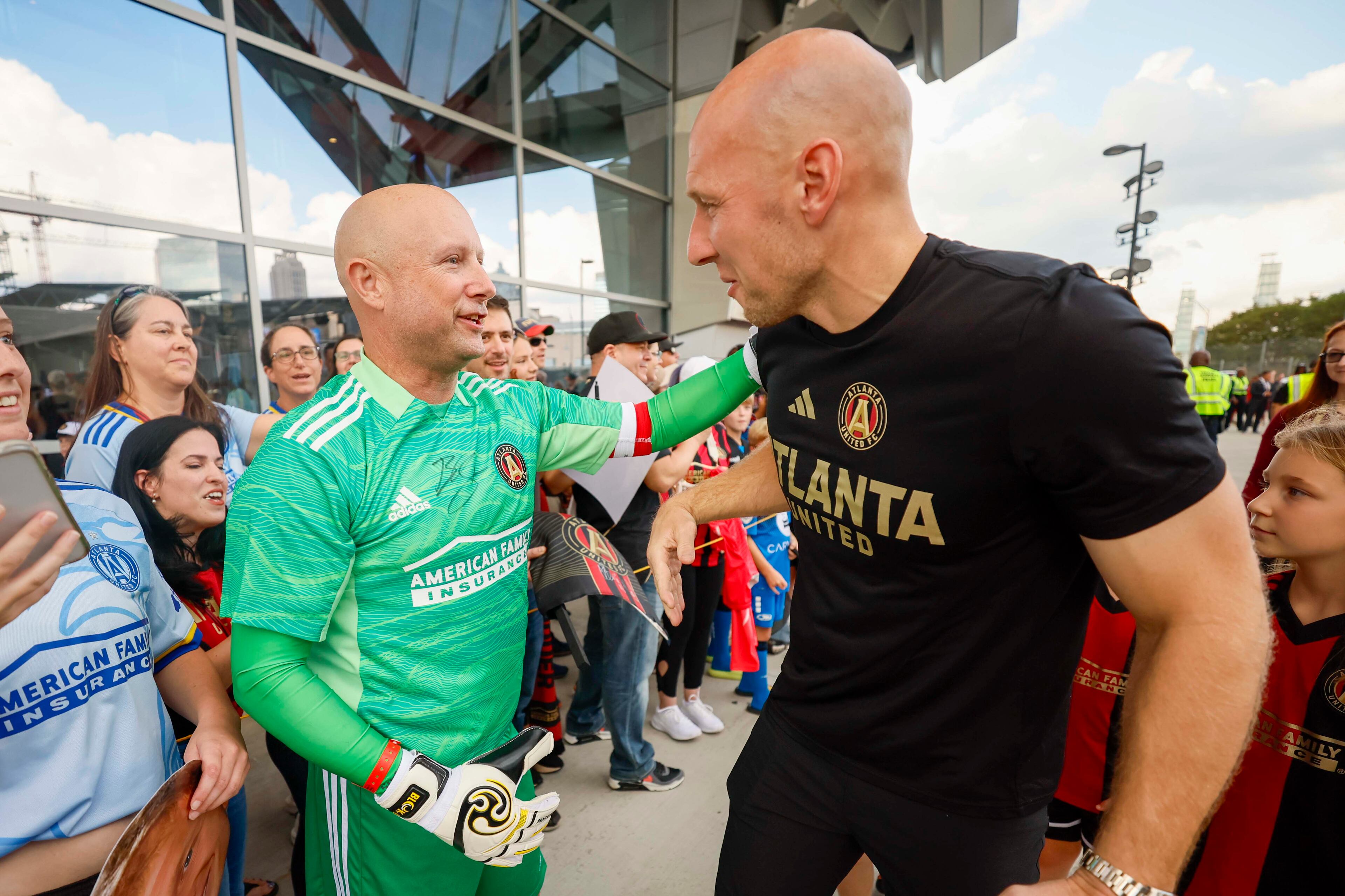 Fan John Bleil (left) sports a goalkeeper outfit while chatting with longtime Atlanta United goalkeeper Brad Guzan before his final pre-retirement match.