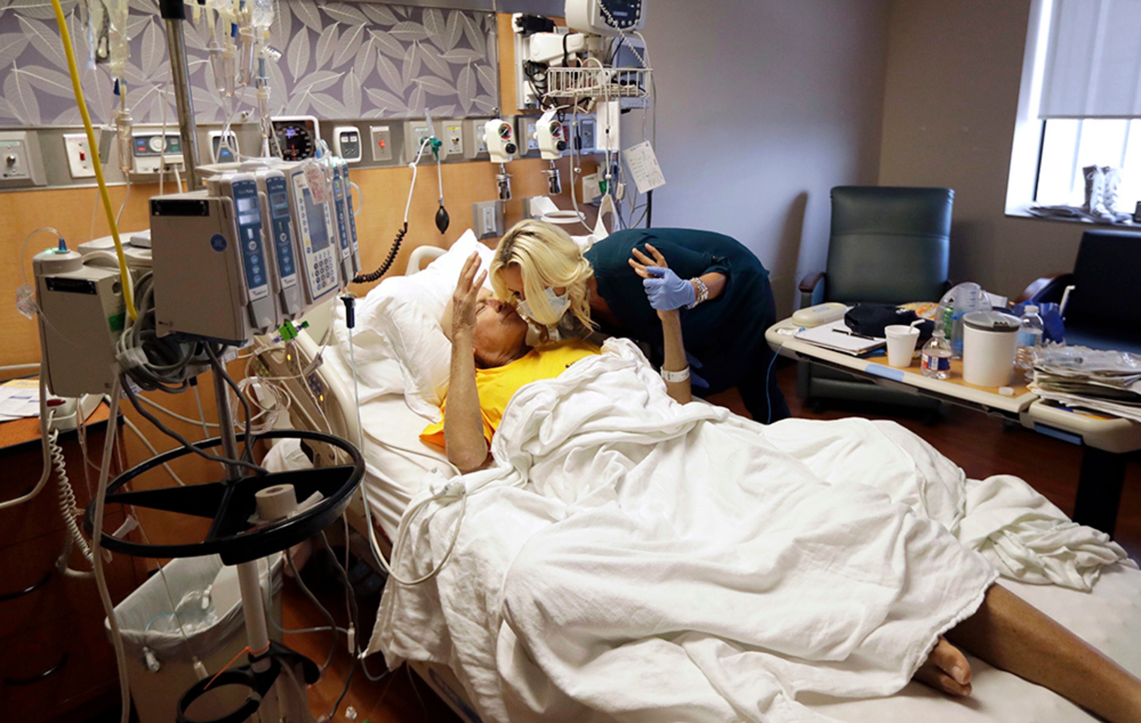 Sportscaster Craig Sager kisses his wife, Stacy, while undergoing treatment Tuesday, Aug. 30, 2016, at MD Anderson Cancer Center in Houston. "When you get stem cells they say it's your new birthday," Stacy explained. "So this is his fourth birthday."