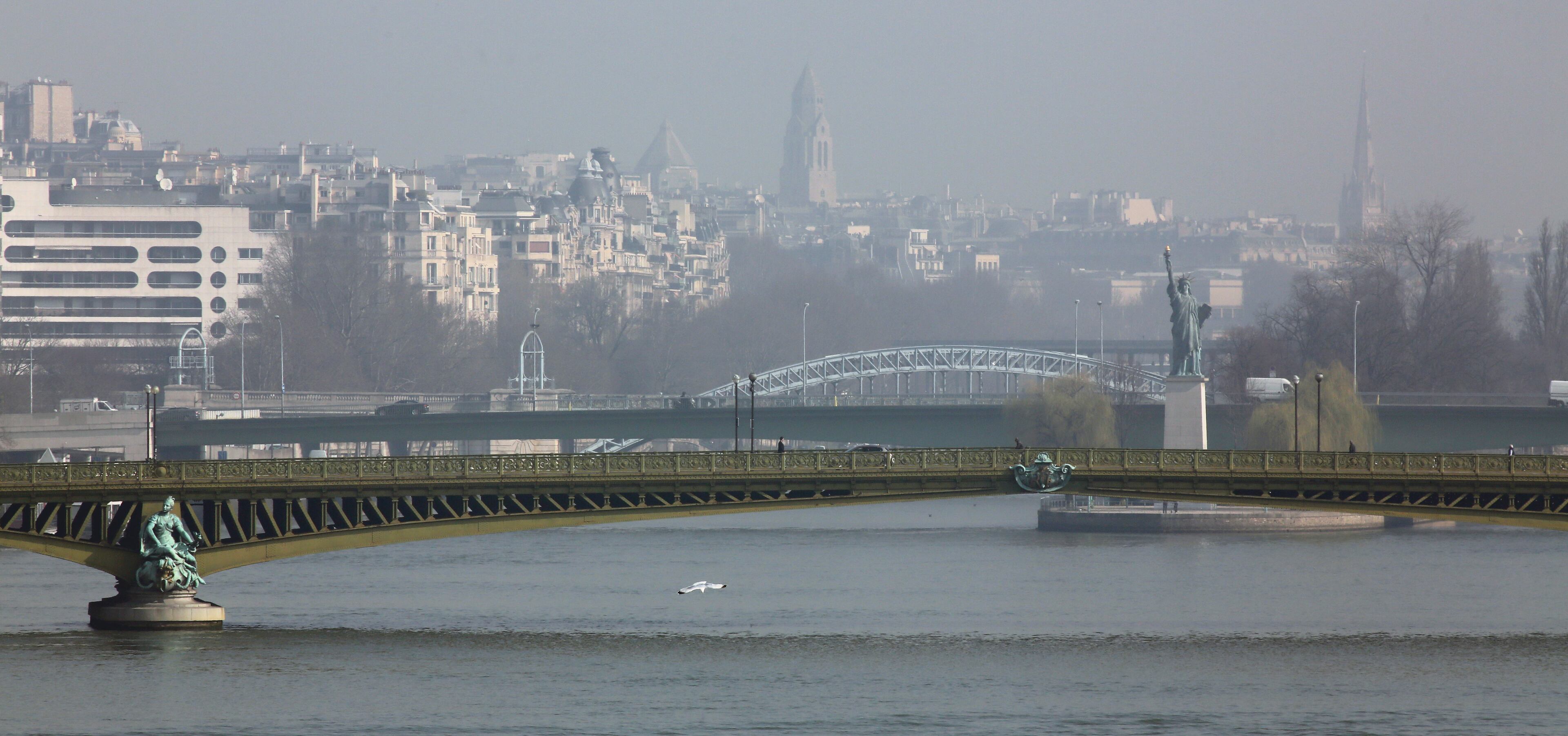 The Mirabeau bridge, and the statue of Liberty, are seen through the smog in Paris, Thursday March 13, 2014 as pollution over the French capital is at high levels.