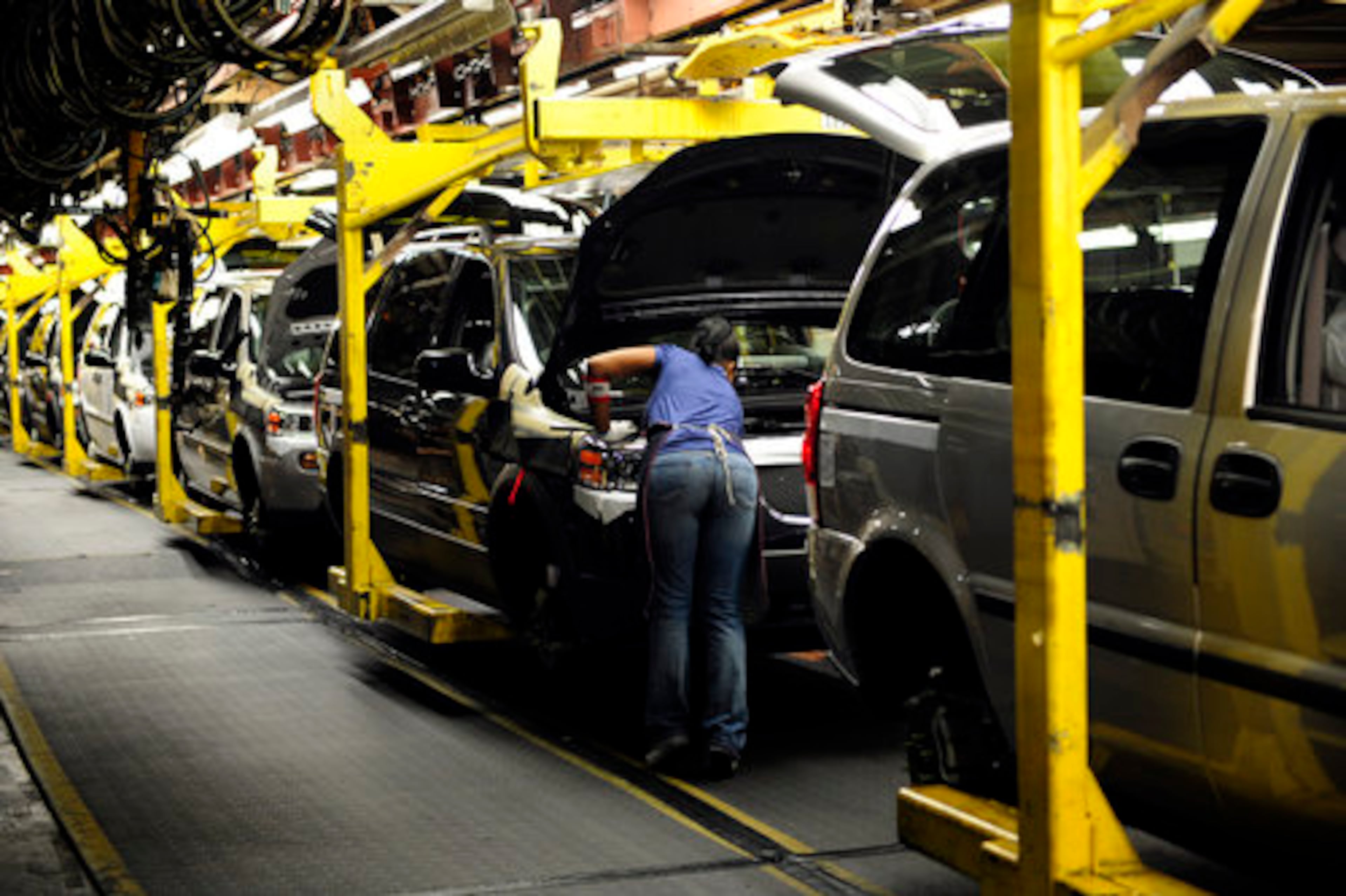 Workers at the General Motors assembly plant in Doraville inspect automobiles on the line. The plant, which employs about 1,200 workers, makes the crossover sport vans Buick Terraza, Pontiac Montana SV6, Chevy Uplander and Saturn Relay. The plant will close Friday, Sept. 26, 2008, as part of a companywide downsizing by the automotive giant, sparked by sluggish sales and heated foreign competition.