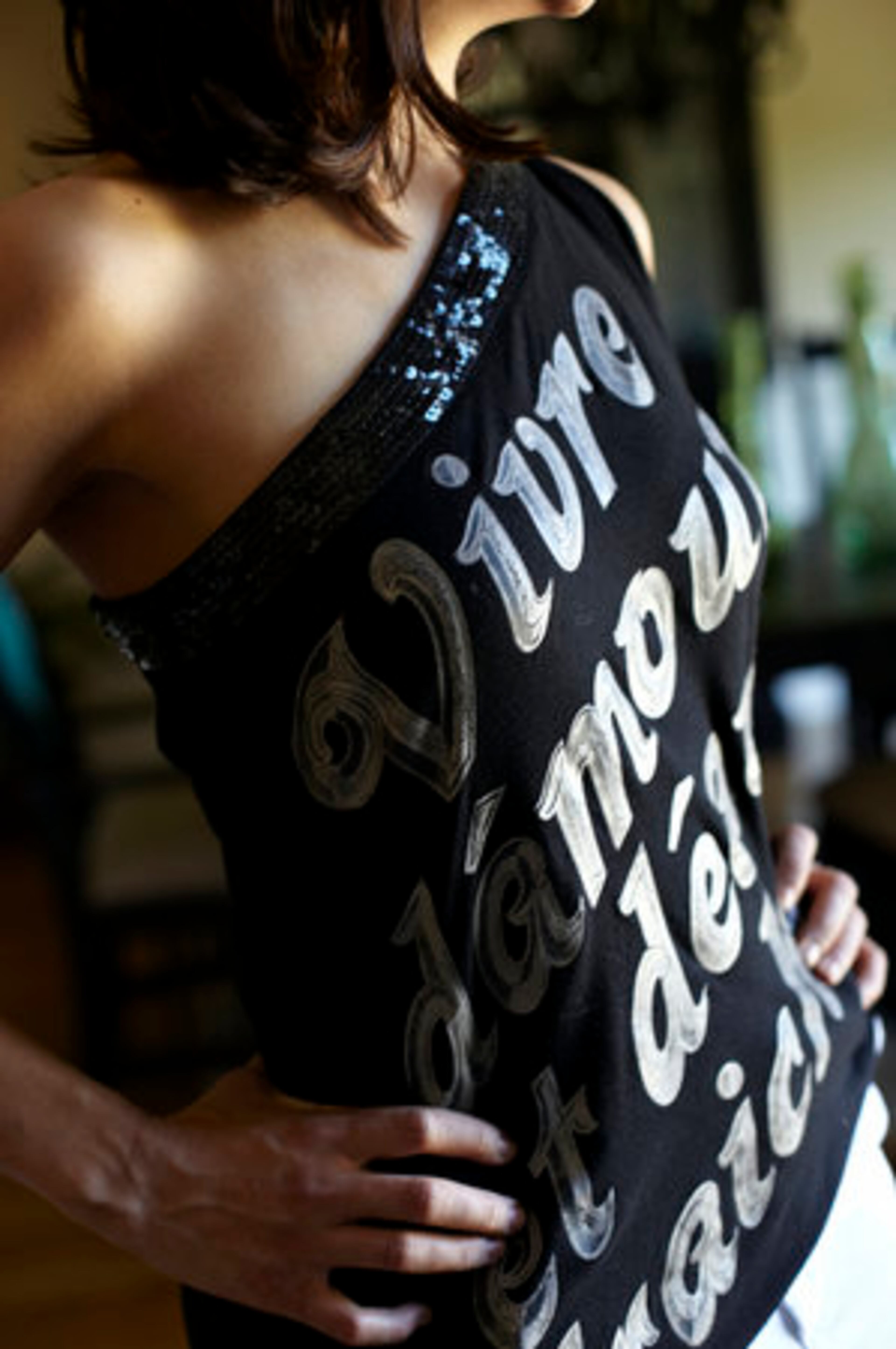 FAVORITE STORES: "Express, Saks Fifth Avenue, Forever 21, and tons in Brazil where I go every year." She purchased this one-shoulder top with sequin detailing from Brazil, which roughly translates from French to, "Living with fresh air and happiness."