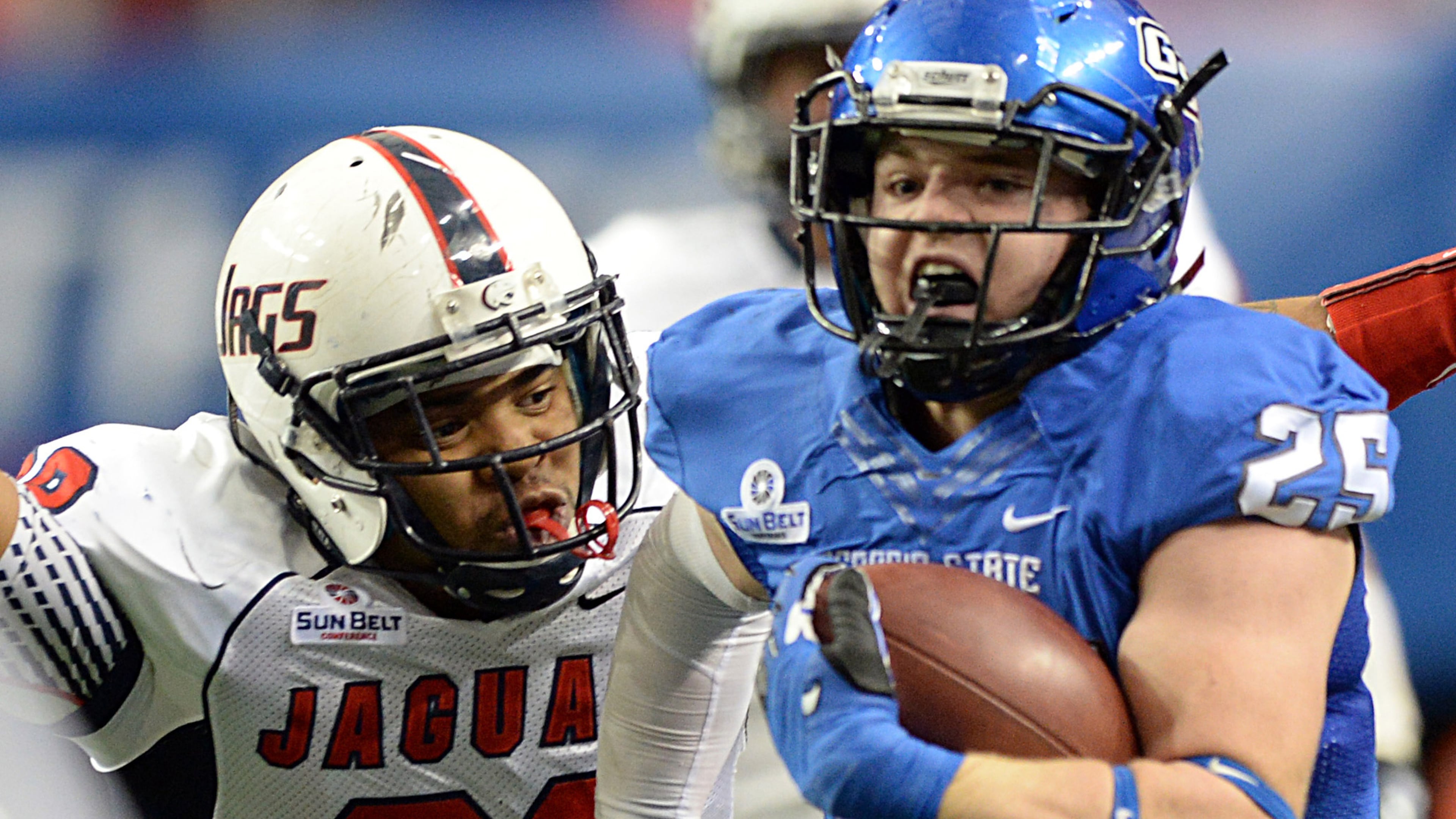 November 30, 2013 Atlanta - Georgia State Panthers running back Kyler Neal (25) runs past South Alabama Jaguars Enrique Williams (28) in the first half at the Georgia Dome on Saturday, November 30, 2013. HYOSUB SHIN / HSHIN@AJC.COM