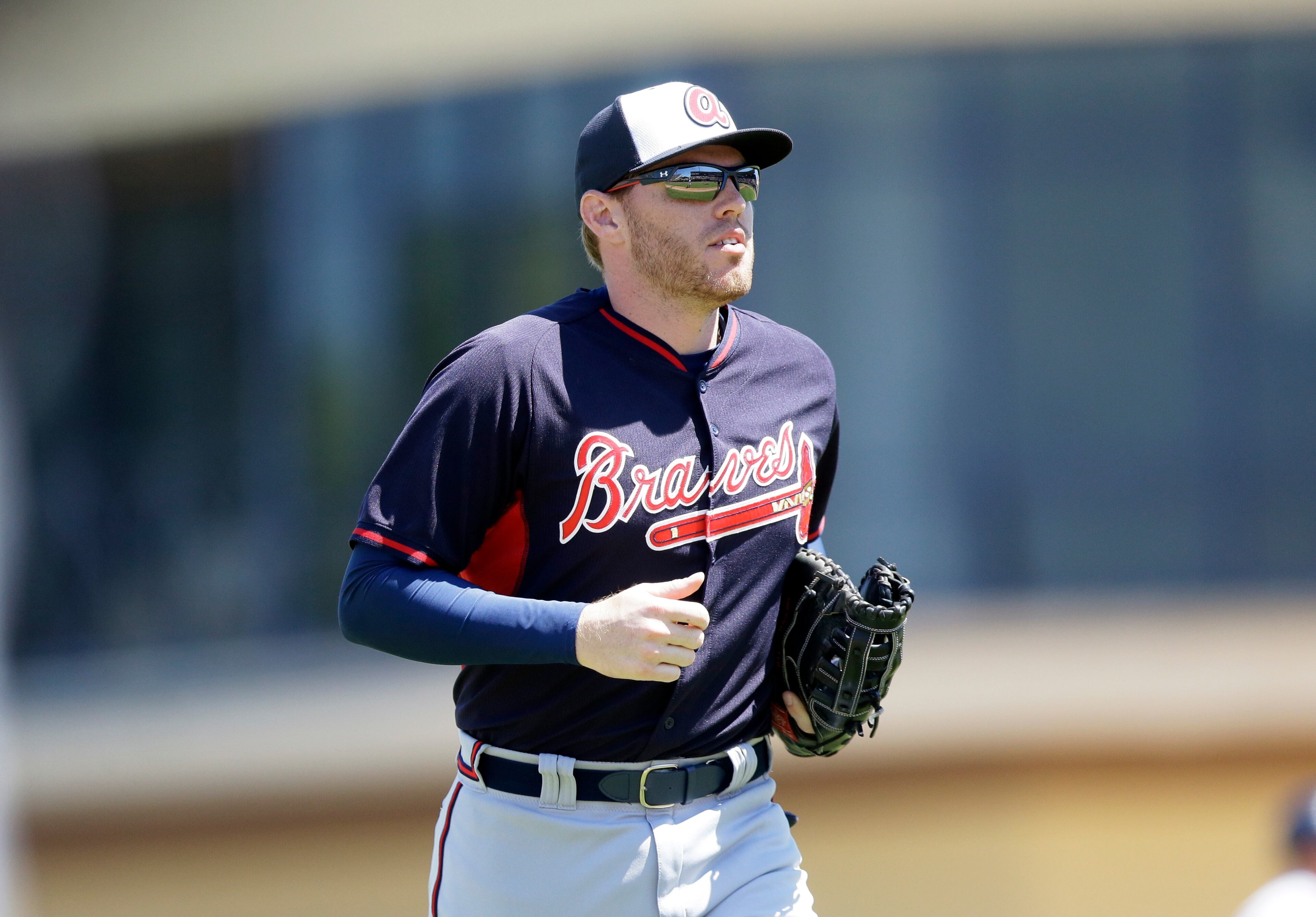 Atlanta Braves first baseman Freddie Freeman runs to the dugout during a spring training exhibition baseball game against the Detroit Tigers in Lakeland, Fla., Monday, March 30, 2015. (AP Photo/Carlos Osorio)