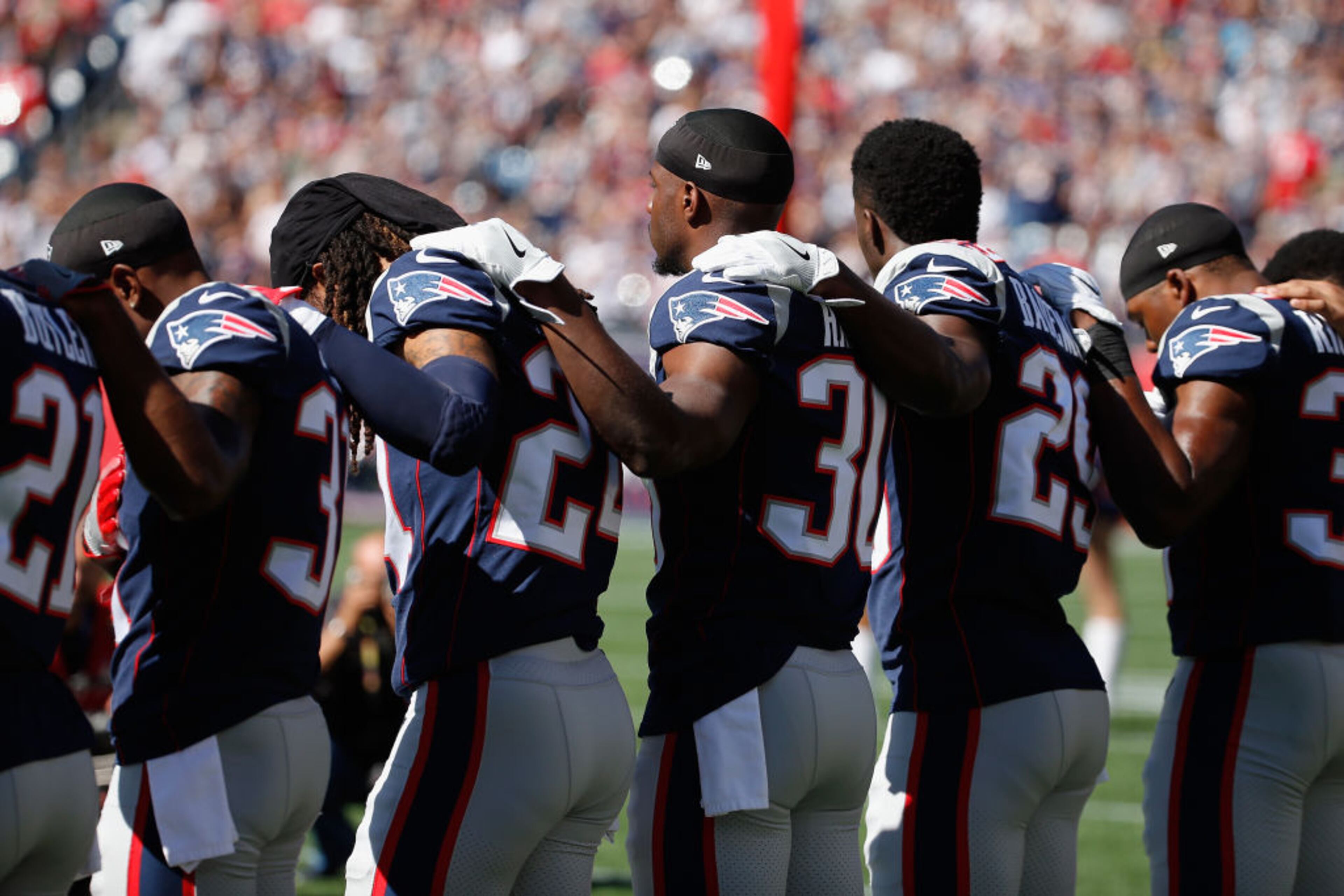 FOXBORO, MA - OCTOBER 01: New England Patriots players stand for the national anthem before their game against the Carolina Panthers at Gillette Stadium on October 1, 2017 in Foxboro, Massachusetts. (Photo by Jim Rogash/Getty Images)