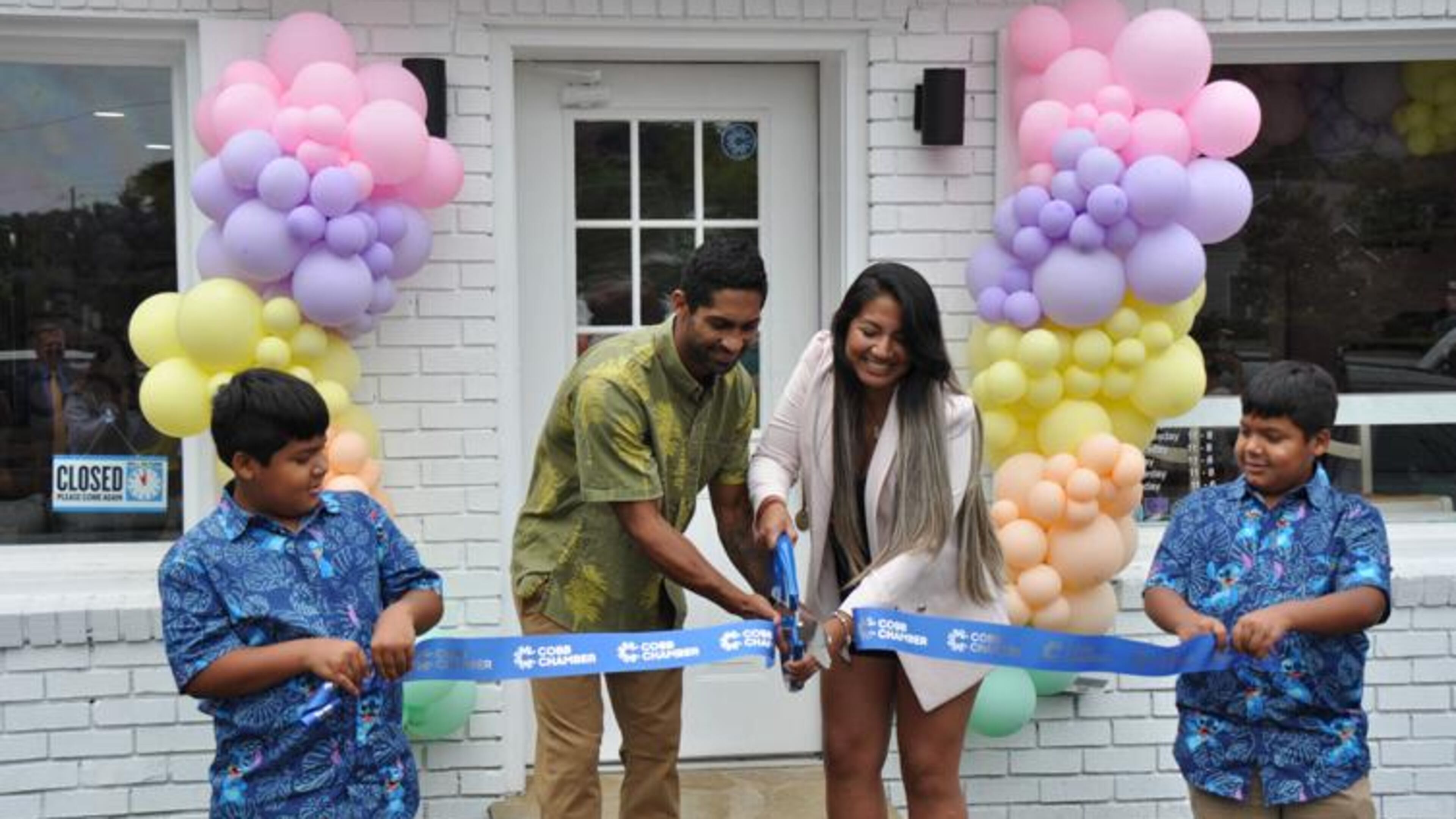 Owners Ikaika and Pierina Anderson cut the ribbon for the grand opening of their shop while twins Kekoa and Keoni Anderson hold the ribbon. (Courtesy of Olivia Wakim)