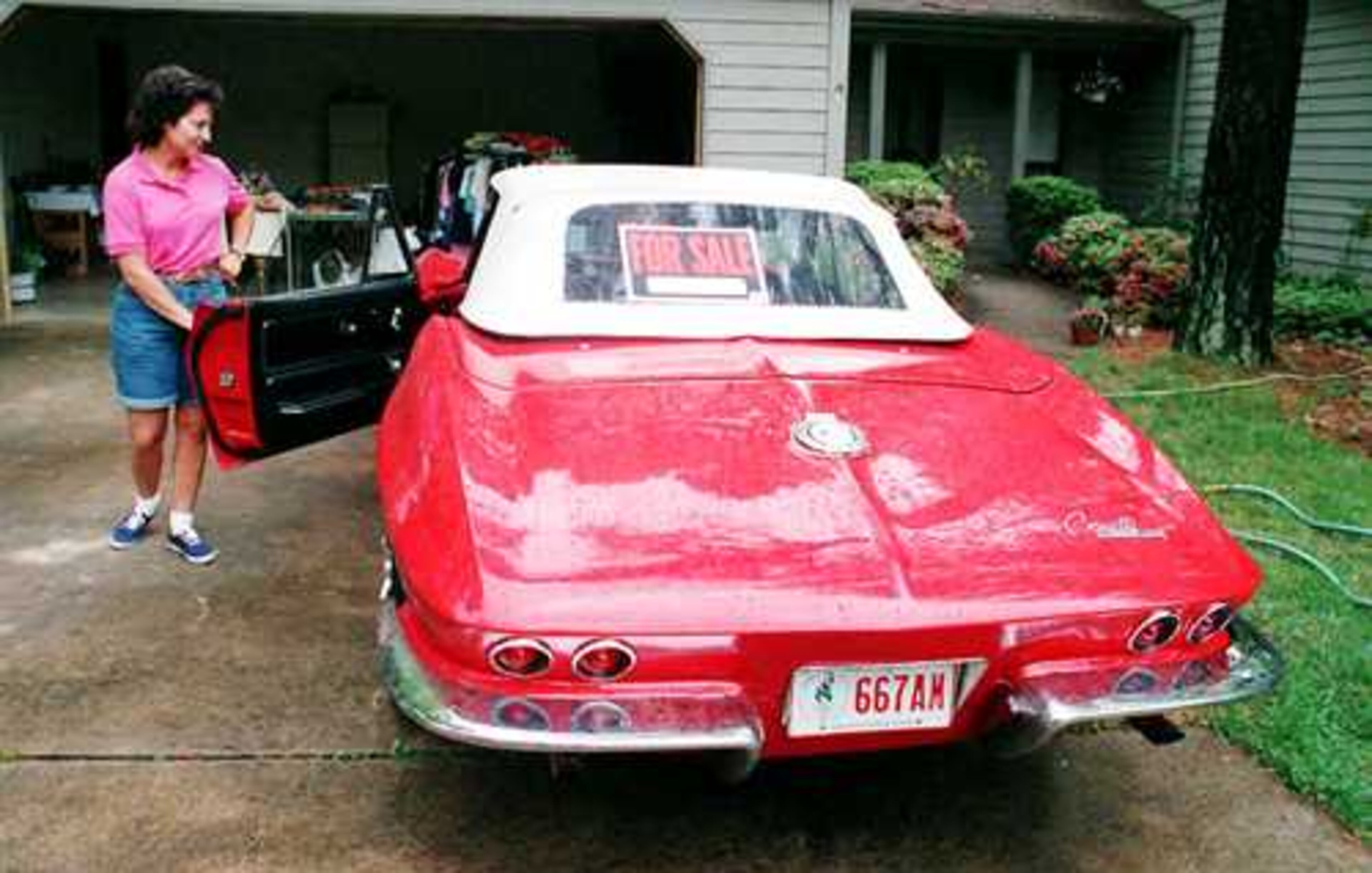 1965 Corvette convertible: Gina Fricks looks over a 1965 Corvette convertible.