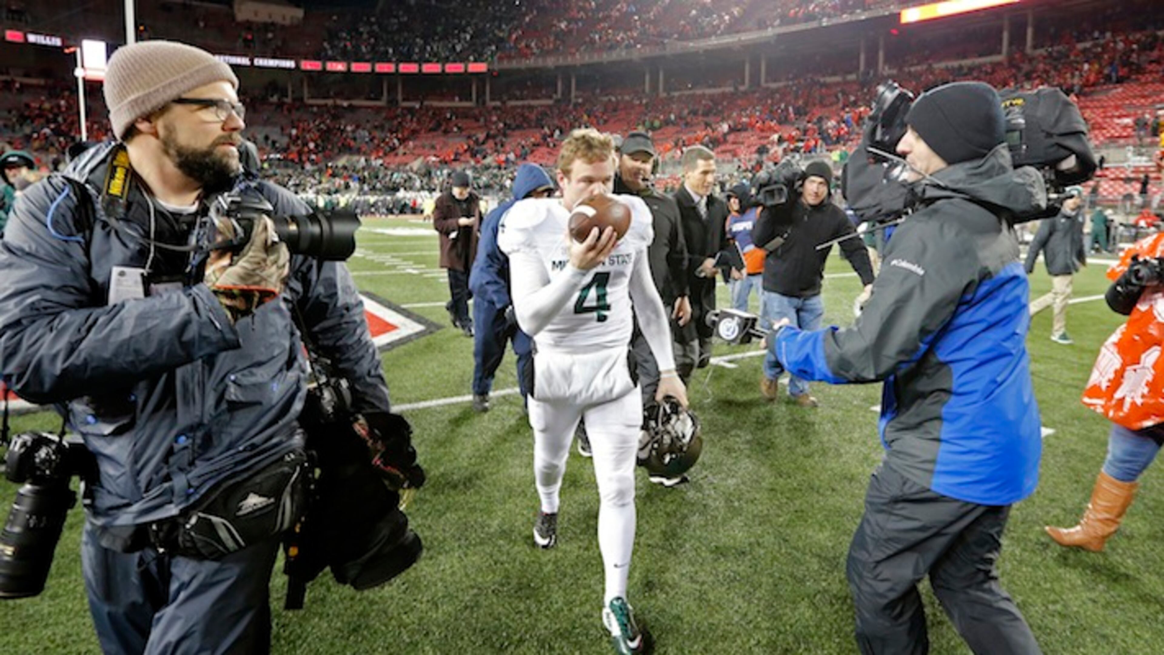 Michigan State kicker Michael Geiger (4) kisses the game ball as he walks off the field after their 17-14 win over Ohio State in an NCAA college football game, Saturday, Nov. 21, 2015, in Columbus, Ohio. Geiger kicked the winning field goal as time expired in the game. (Kyle Robertson/The Columbus Dispatch via AP) MANDATORY CREDIT