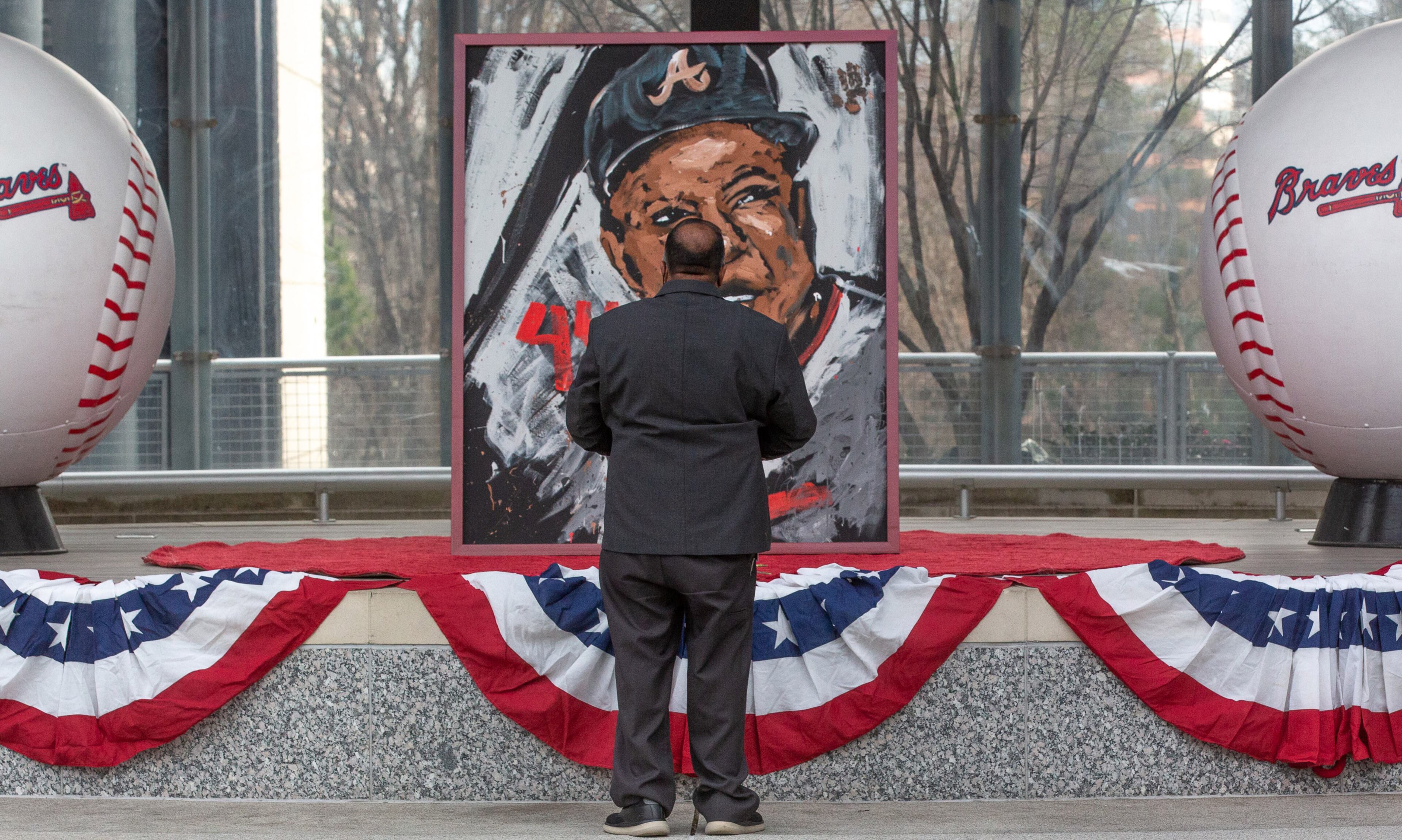 Len Singh pays his respects at a Henry Aaron memorial at Truist Park Atlanta Friday. STEVE SCHAEFER FOR THE ATLANTA JOURNAL-CONSTITUTION