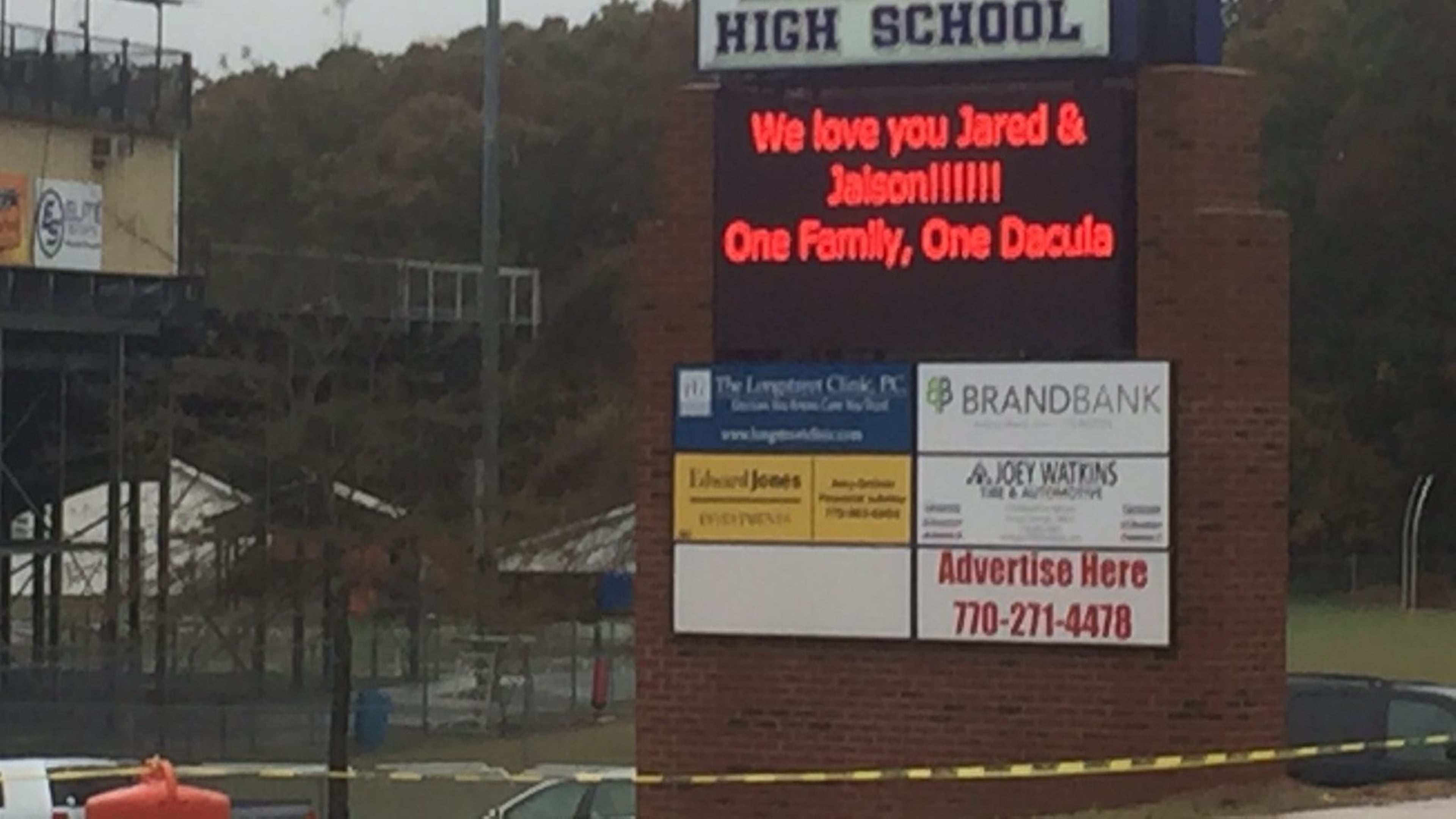 The sign outside Dacula High School Monday afternoon remembers Jared and Jaison Brown, students killed on their way to school Friday in an auto accident. ERIC STIRGUS/STAFF